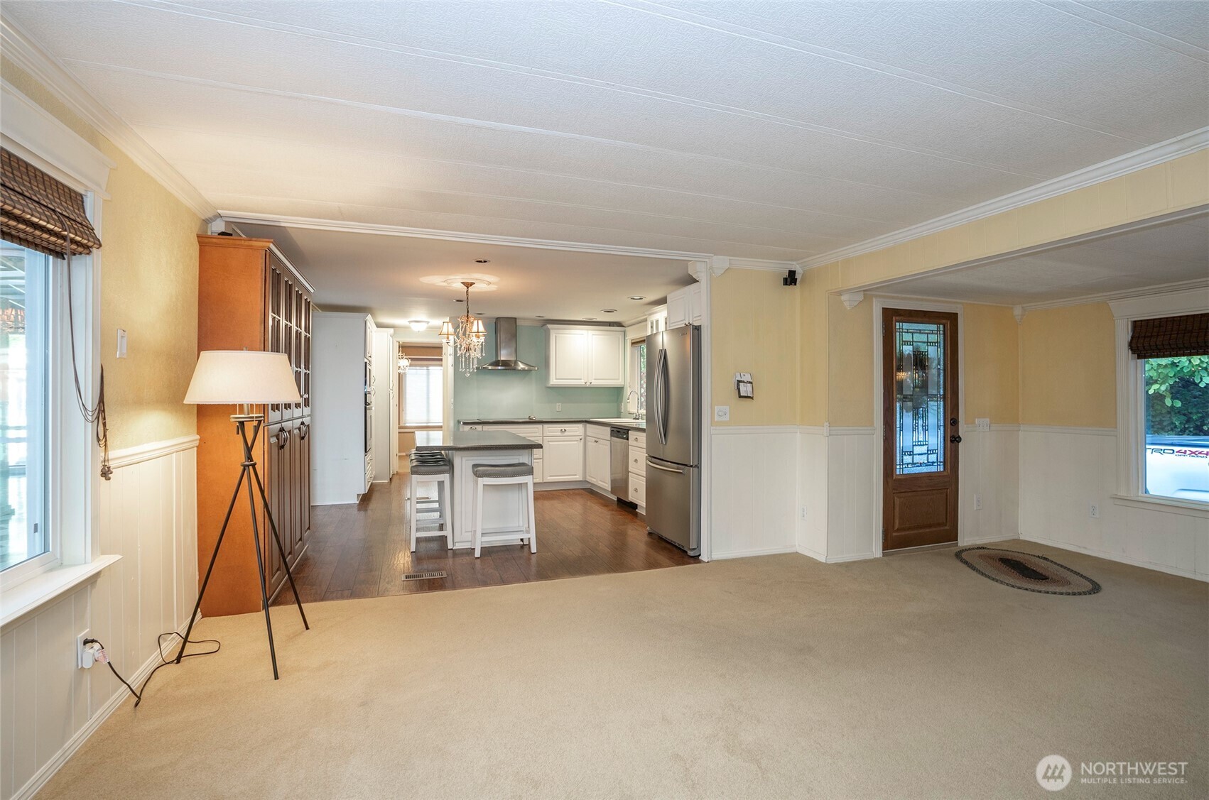 Side door to the detached garage with extra covered storage—ideal for all your needs!