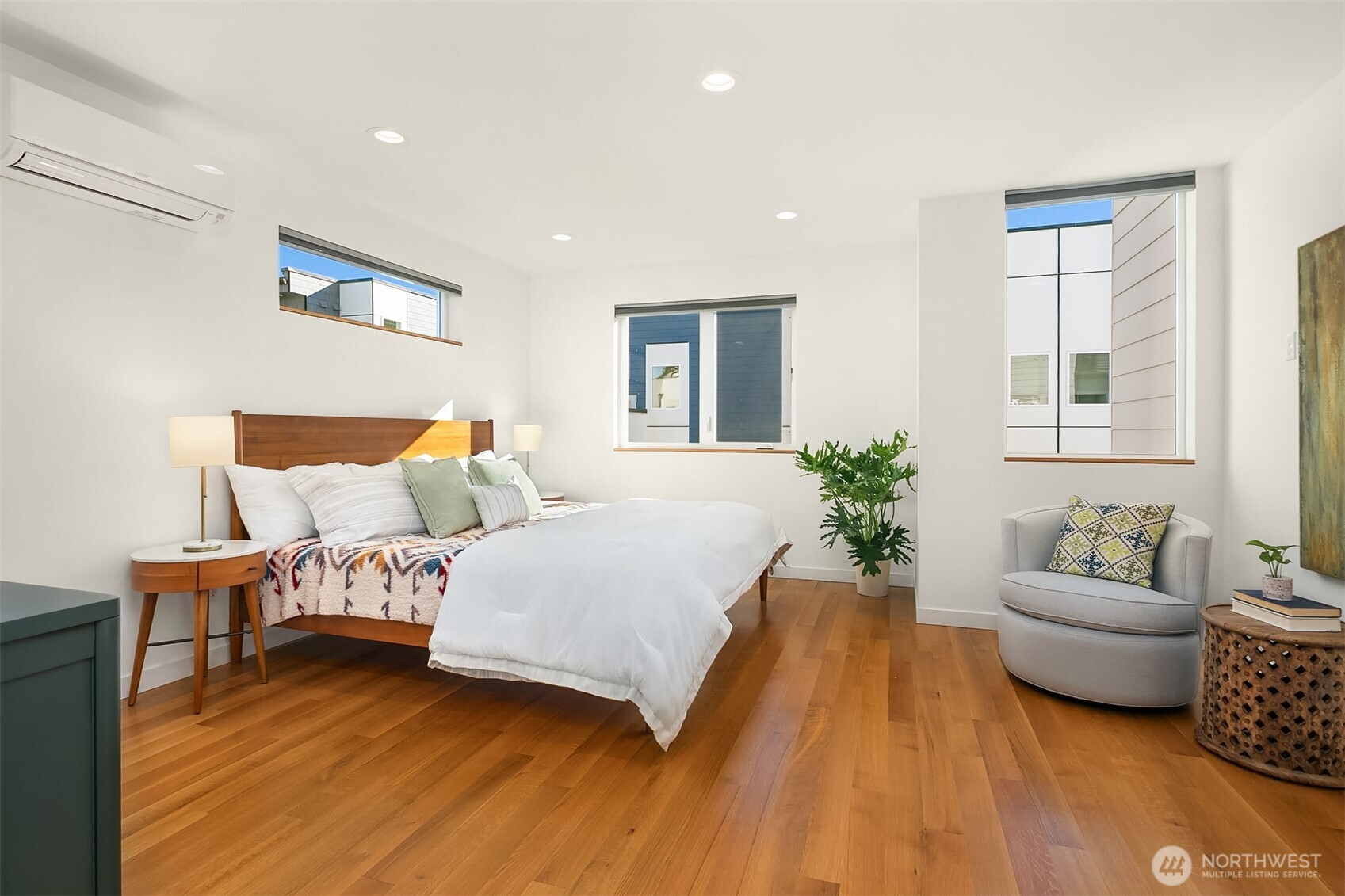 Huge primary bedroom with walk-in closet and modern bathroom.