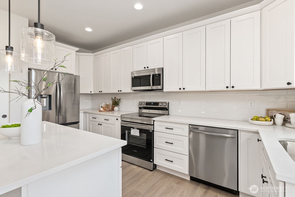 Interior photo shown is from a similar new construction home by the same builder. Fixtures, flooring, floor plan, and finishes are representative and may differ from the home currently under construction.