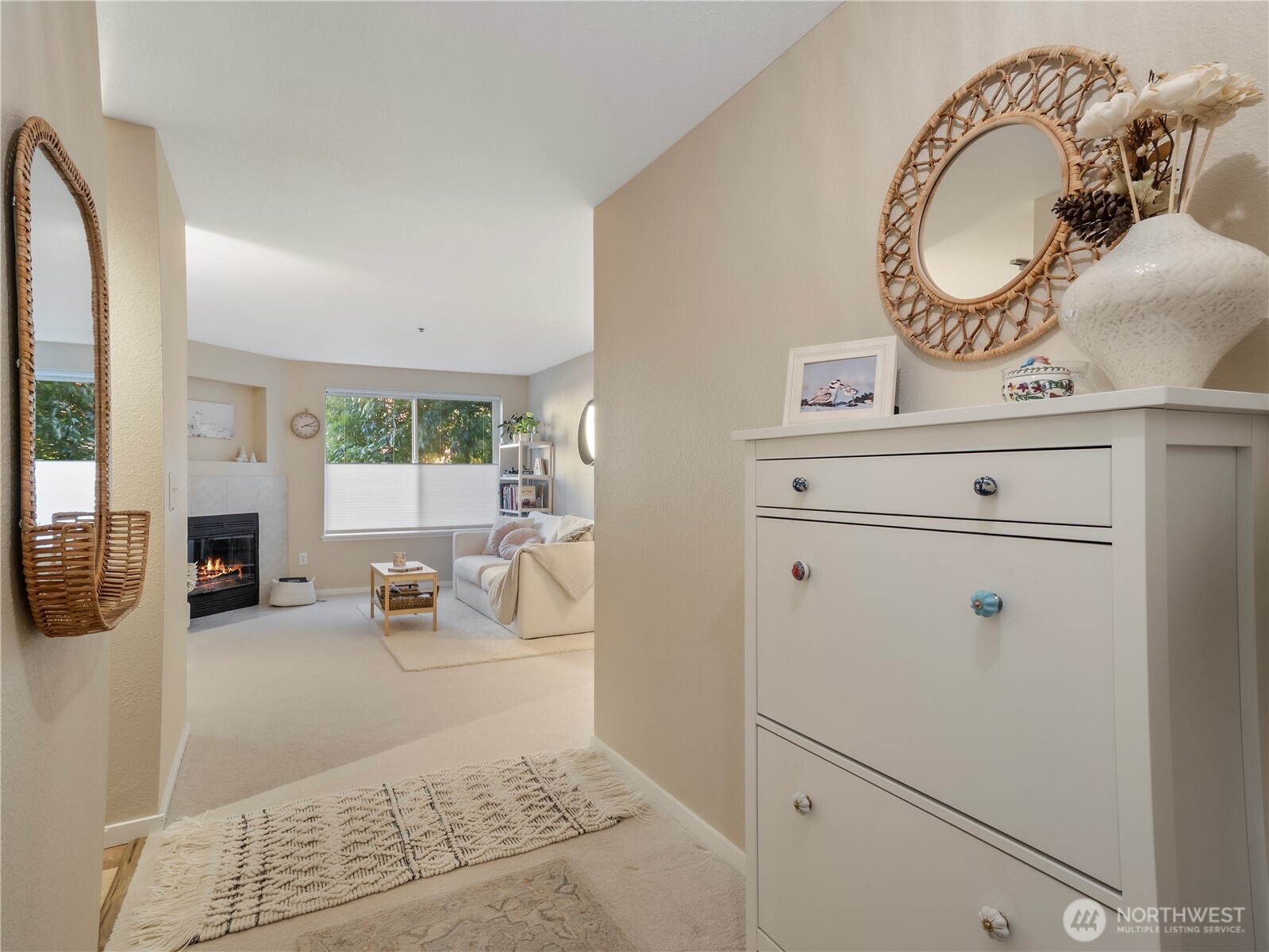 The living room features a cozy wood fireplace with tile surround.