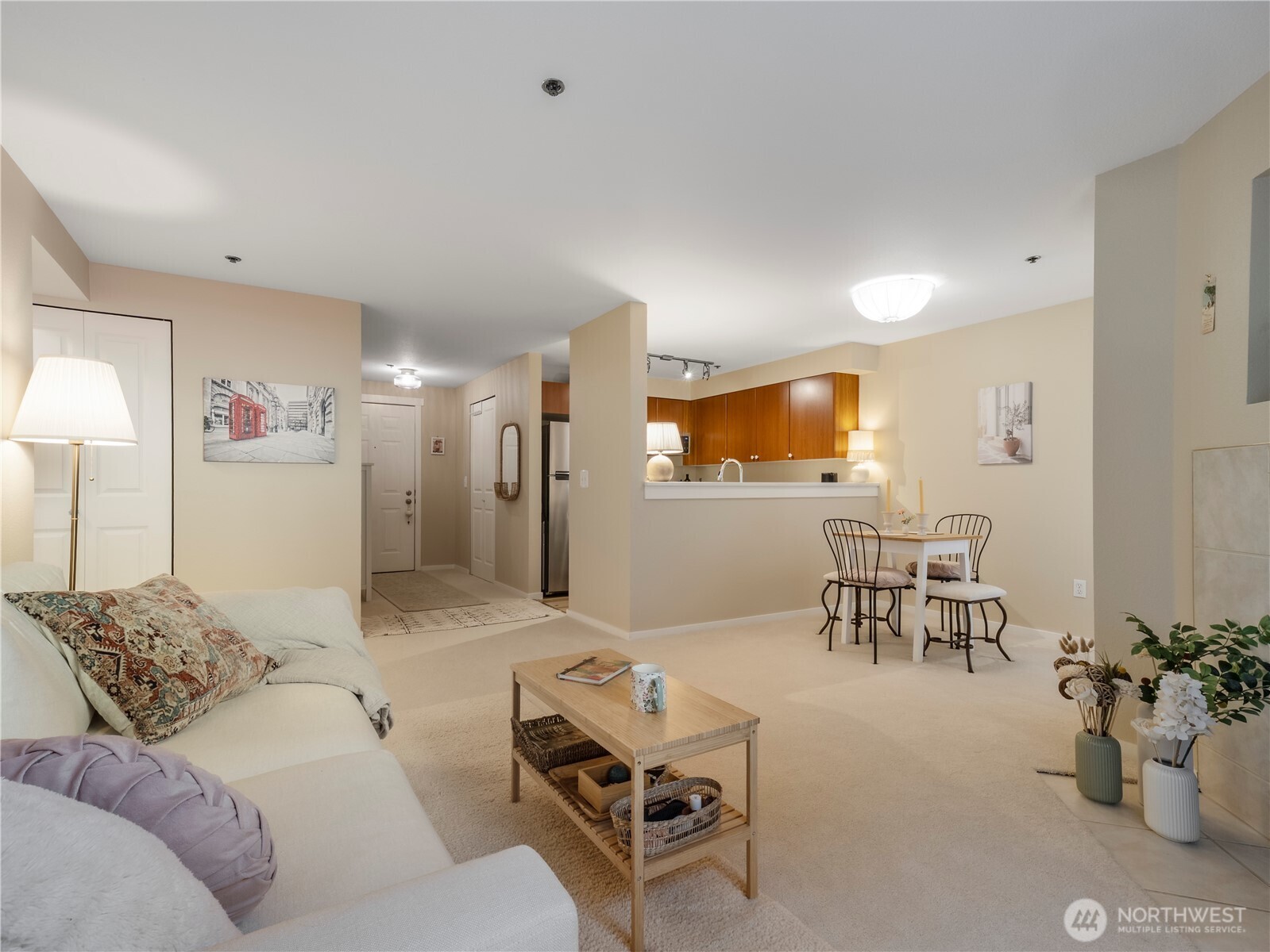 The beautifully updated kitchen with quartz surfaces, stainless steel appliances, and warm-toned LVP floors.