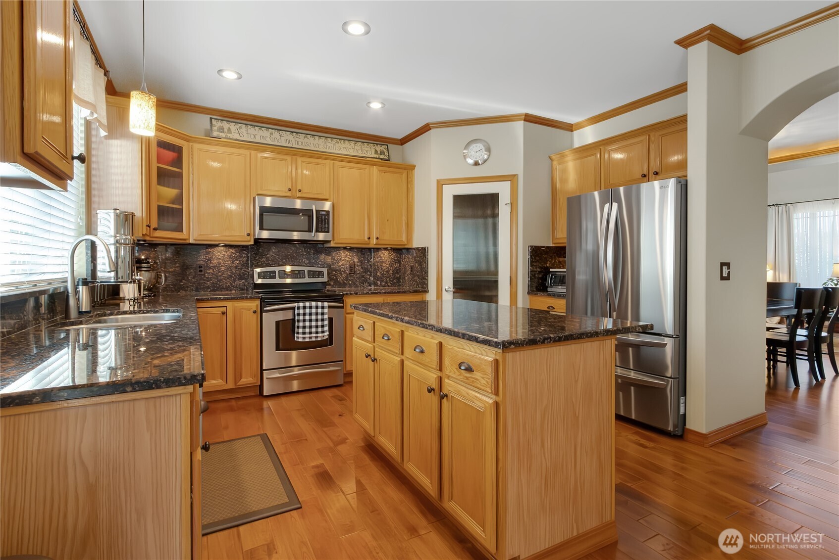Gorgeous kitchen with stainless appliances, walk in pantry and center island.