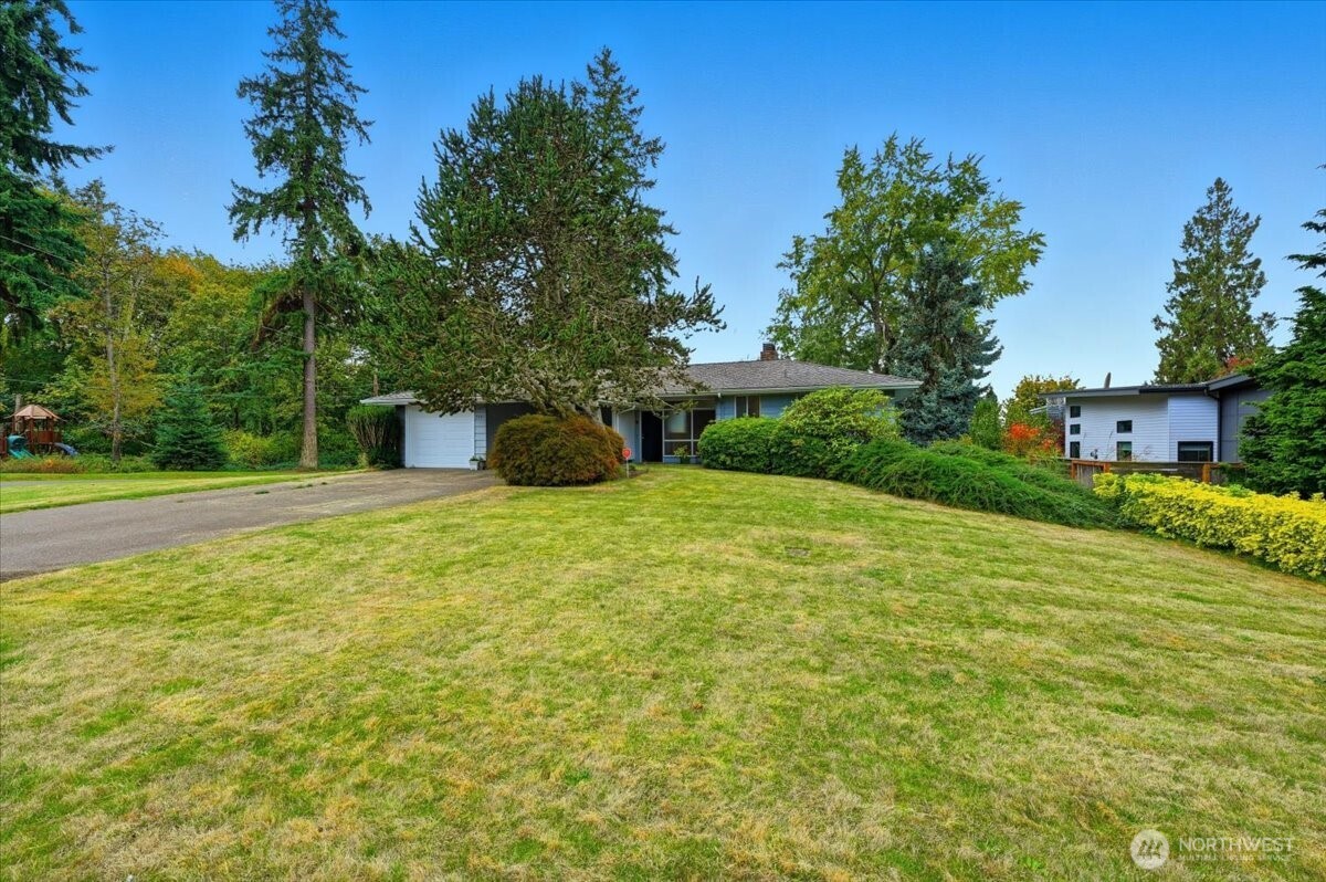 Expansive lawn surrounds existing home.