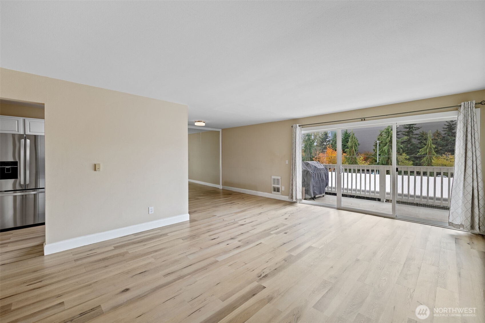 Large living room with lake view and access to large deck.