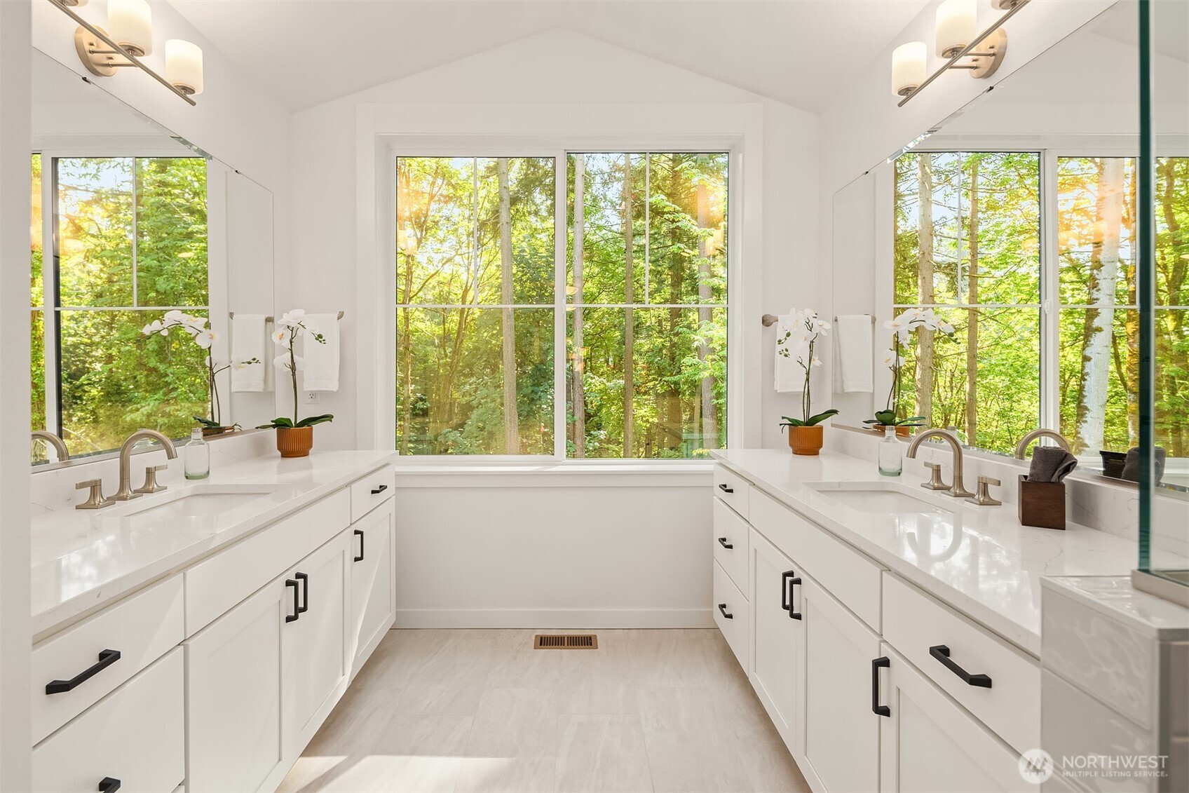 Forest view from primary bath, reflected in the dual vanity mirrors.  The effect is marvelous! Furnished and staged Poppy floor plan.  Surfaces finishes may differ, for demonstration purposes only.