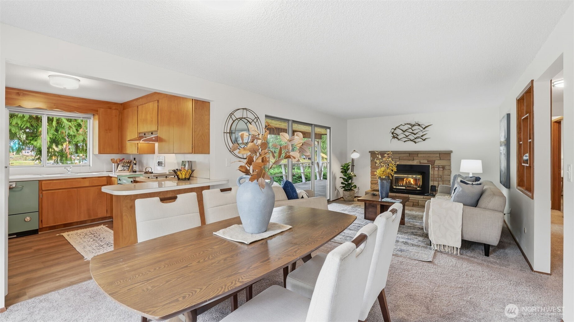 Warm and welcoming living space with a wood-burning insert and large sliding doors that bring the outdoors in.