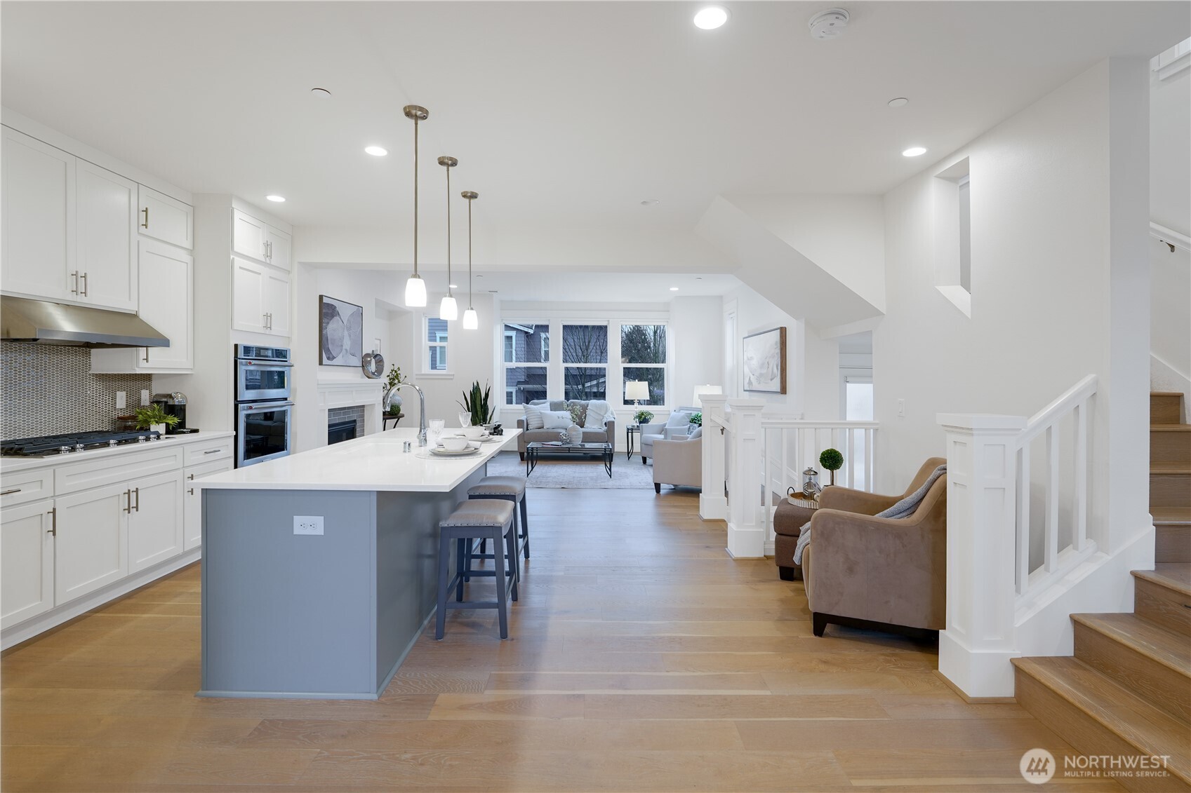 From the dining area looking into the kitchen and the living area beyond.  Note the gorgeous floors and tall ceilings.
