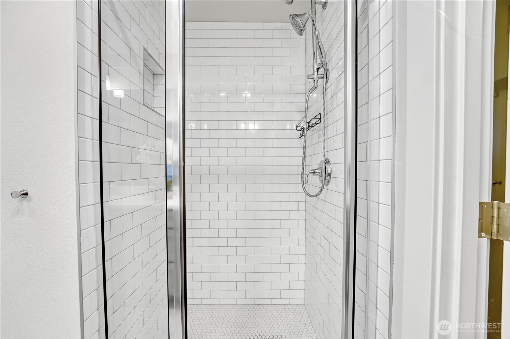 The sleek shower is finished in elegant white metro tile, creating a crisp, timeless look.
