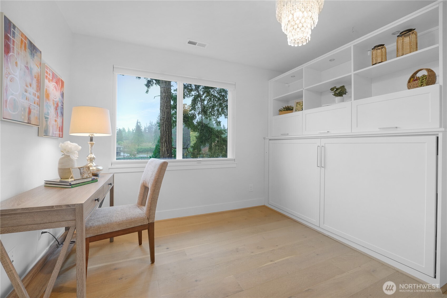 The first of two secondary bedrooms features a large closet and a built-in Murphy bed with additional storage.  This clever setup maximizes space, leaving plenty of room for an in-home office or guest retreat.