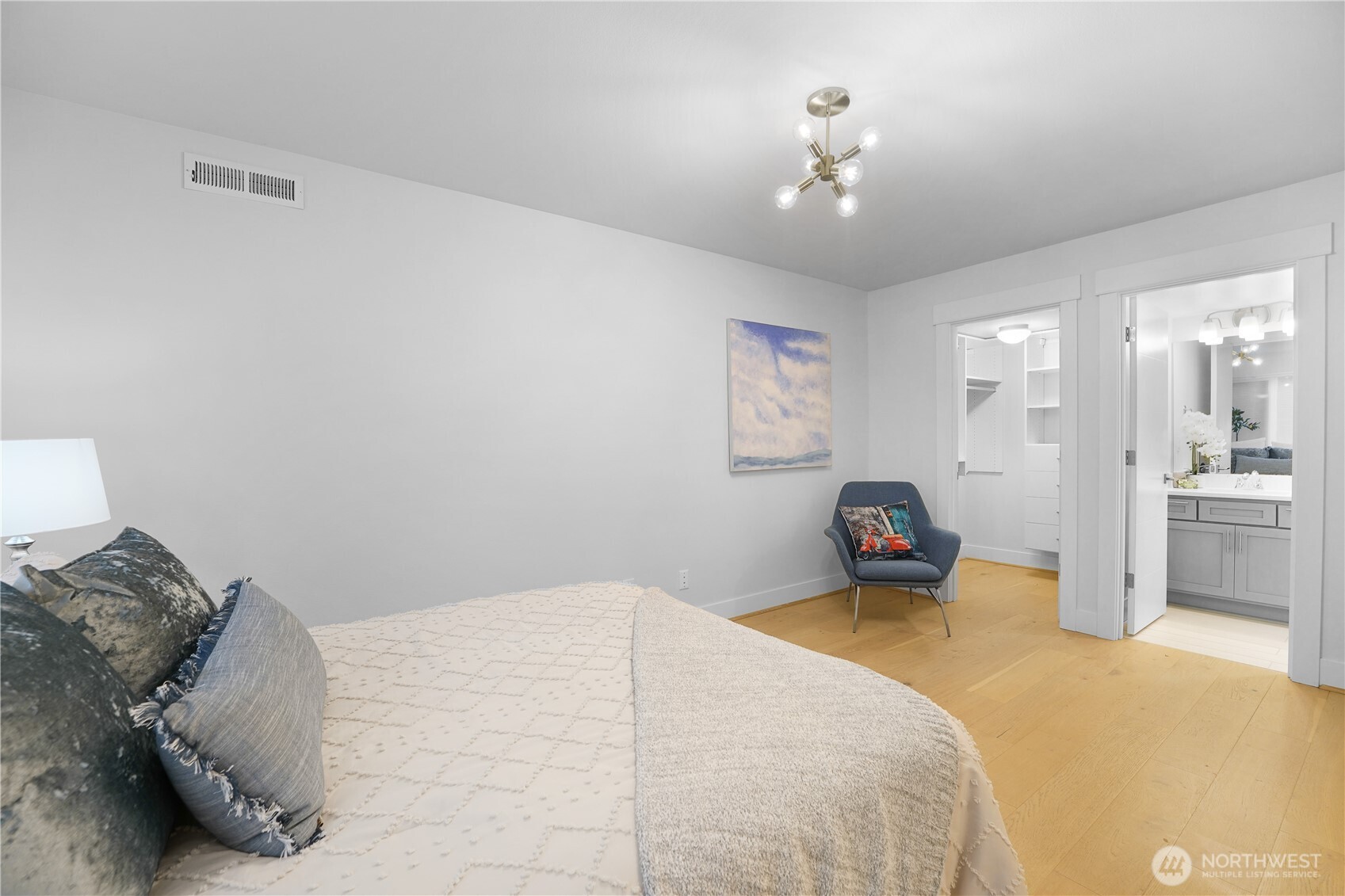 Located near the garage, this spacious bedroom offers comfort and privacy.  A lovely walk-in closet provides ample storage, while the private en-suite bathroom features a walk-in shower for convenience and style.