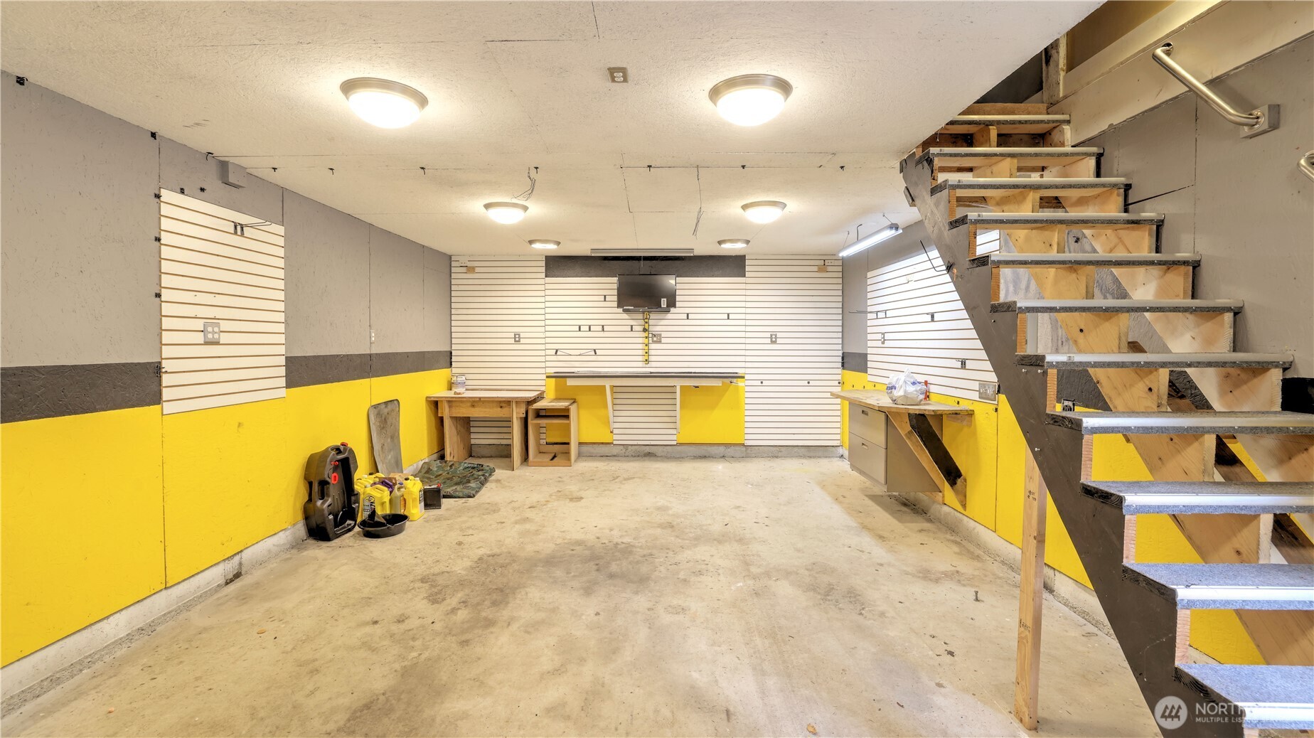 You will love having this large detached garage equipped with work benches and a studio upstairs!