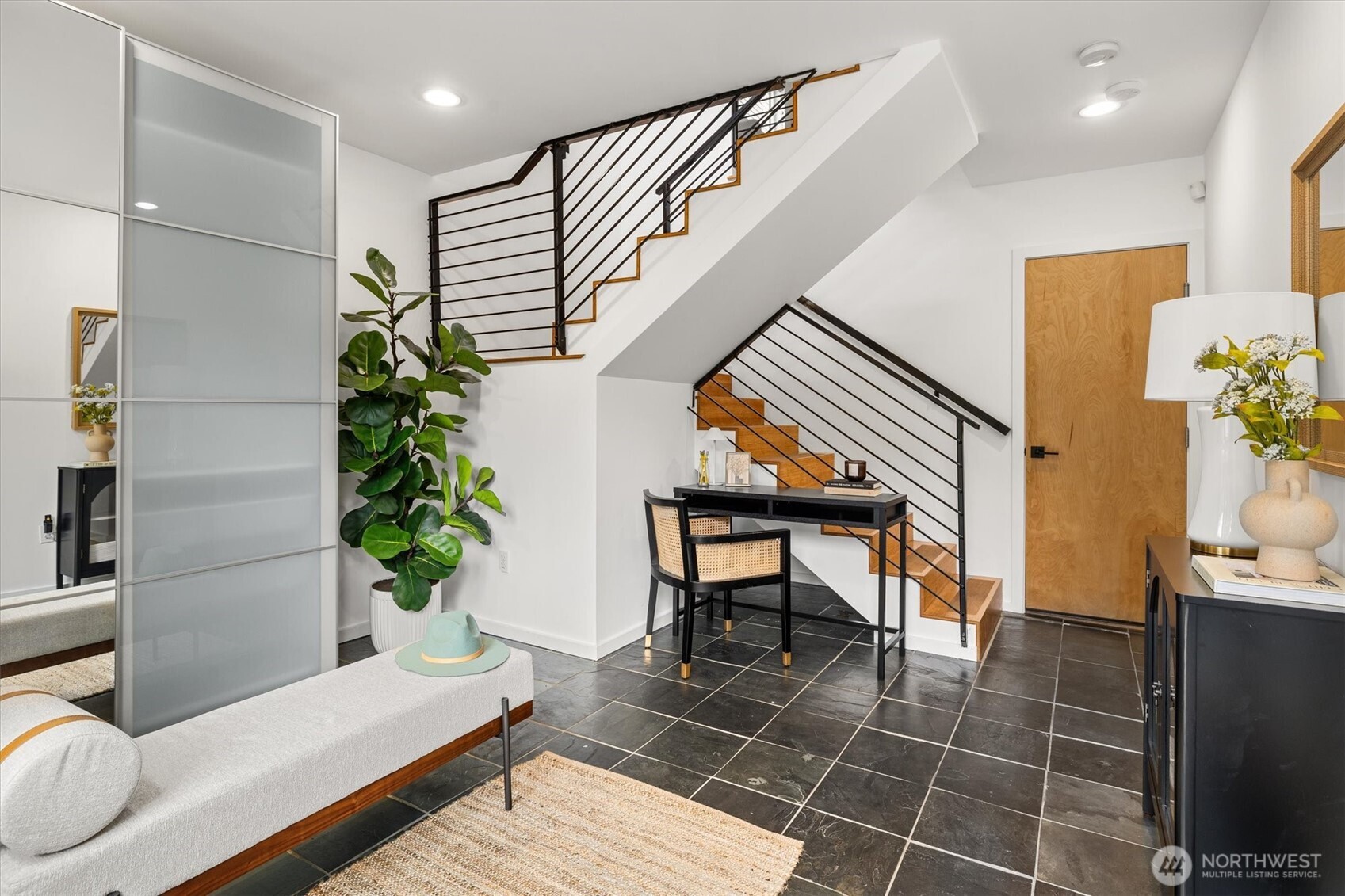 As you enter, gorgeous slate flooring greets you with a storage space that can be combined as a mud room and office nook, or workout space!