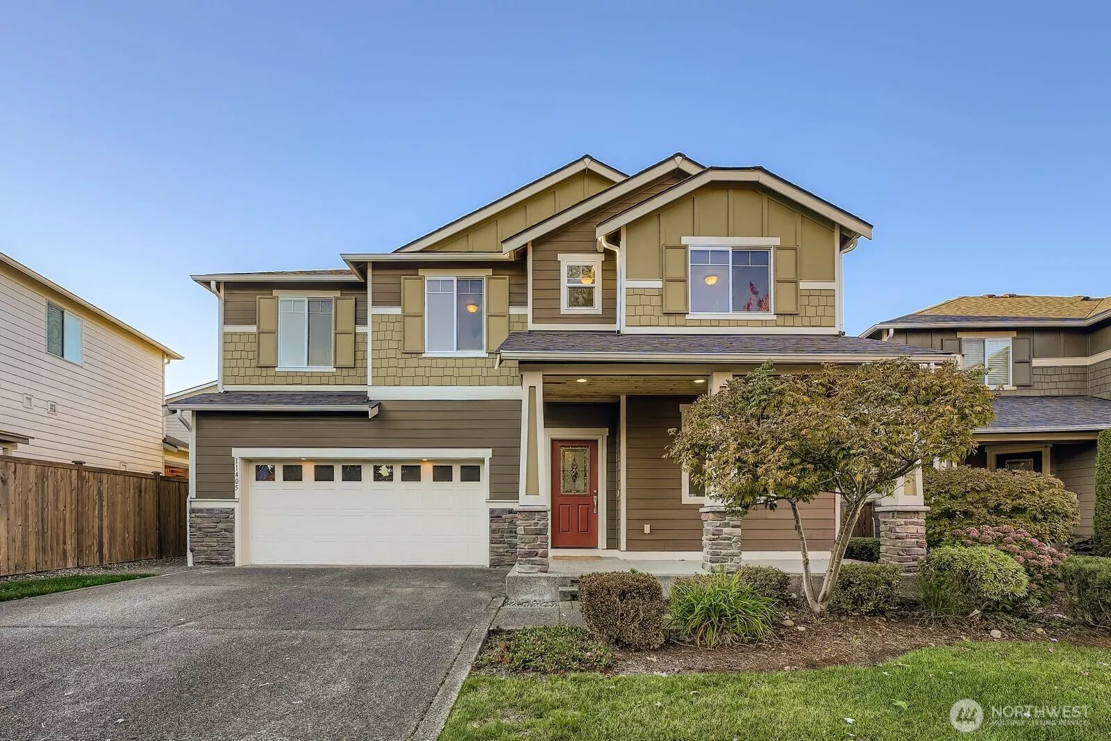 Front exterior with landscaped yard and covered entry.