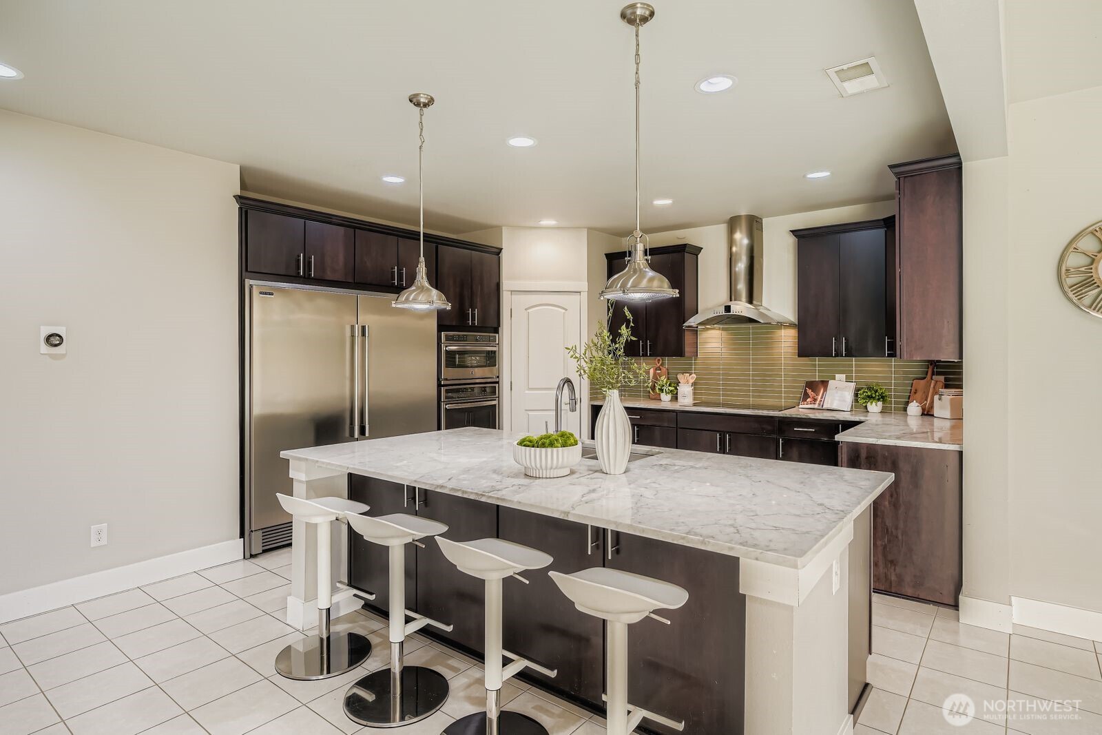 Island is conveniently across from the double refrigerator & freezer.