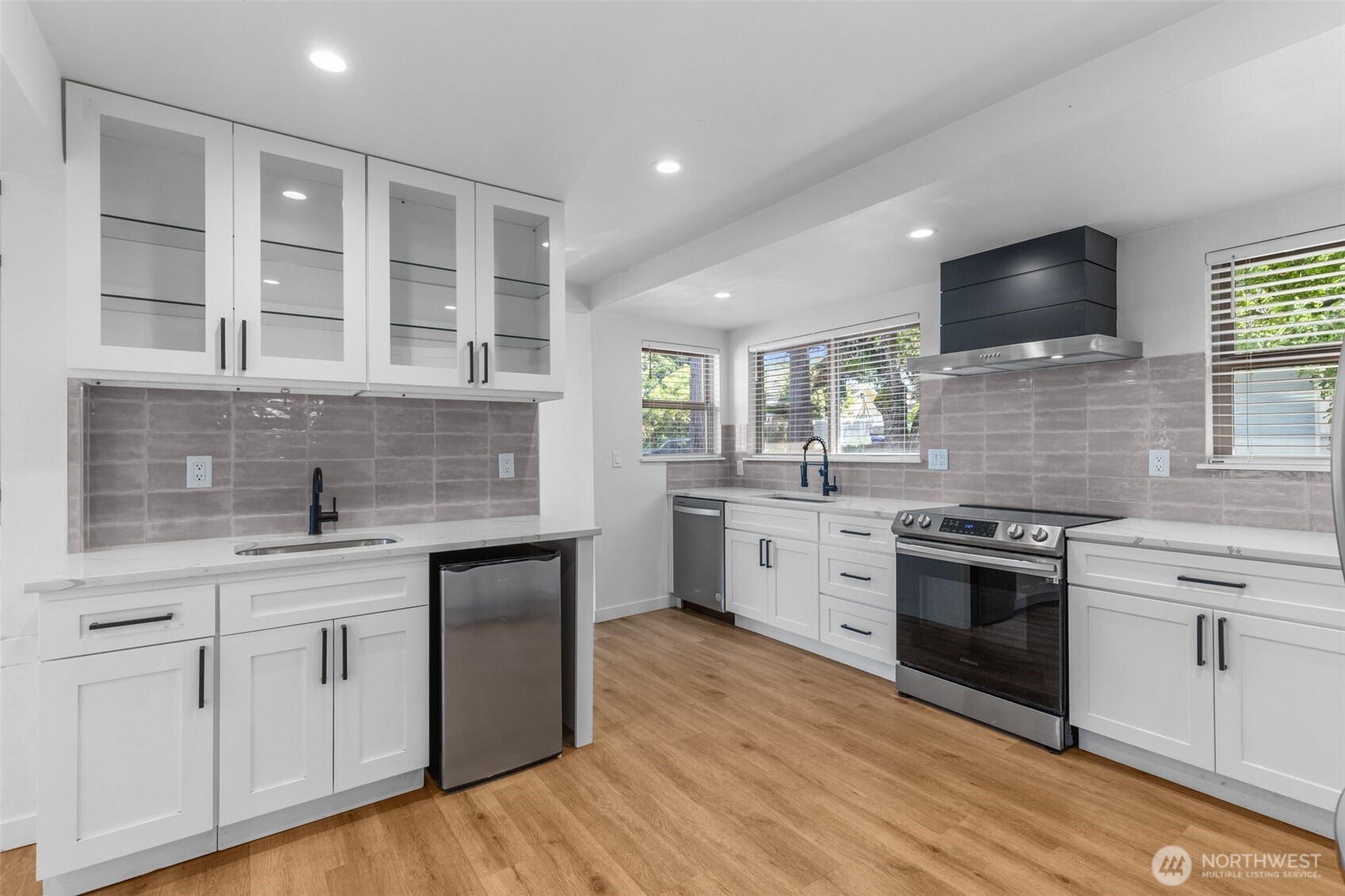 Entertain in style with a designer kitchen, wine fridge, and wet bar.