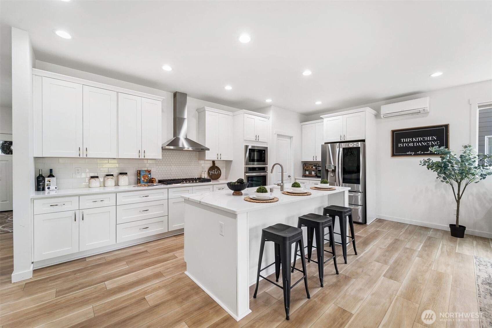 Gourmet kitchen with quartz countertops, designer backsplash, stainless steel appliances