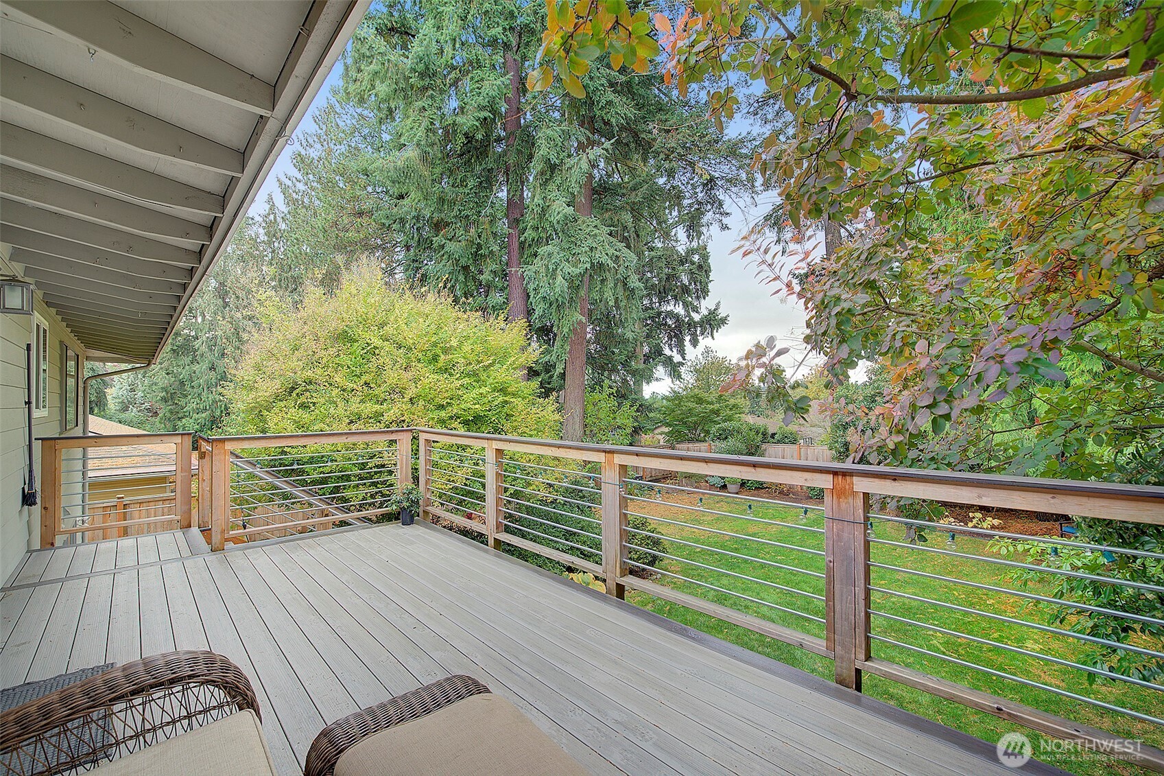 Specious deck overlooks private fully-fenced backyard.