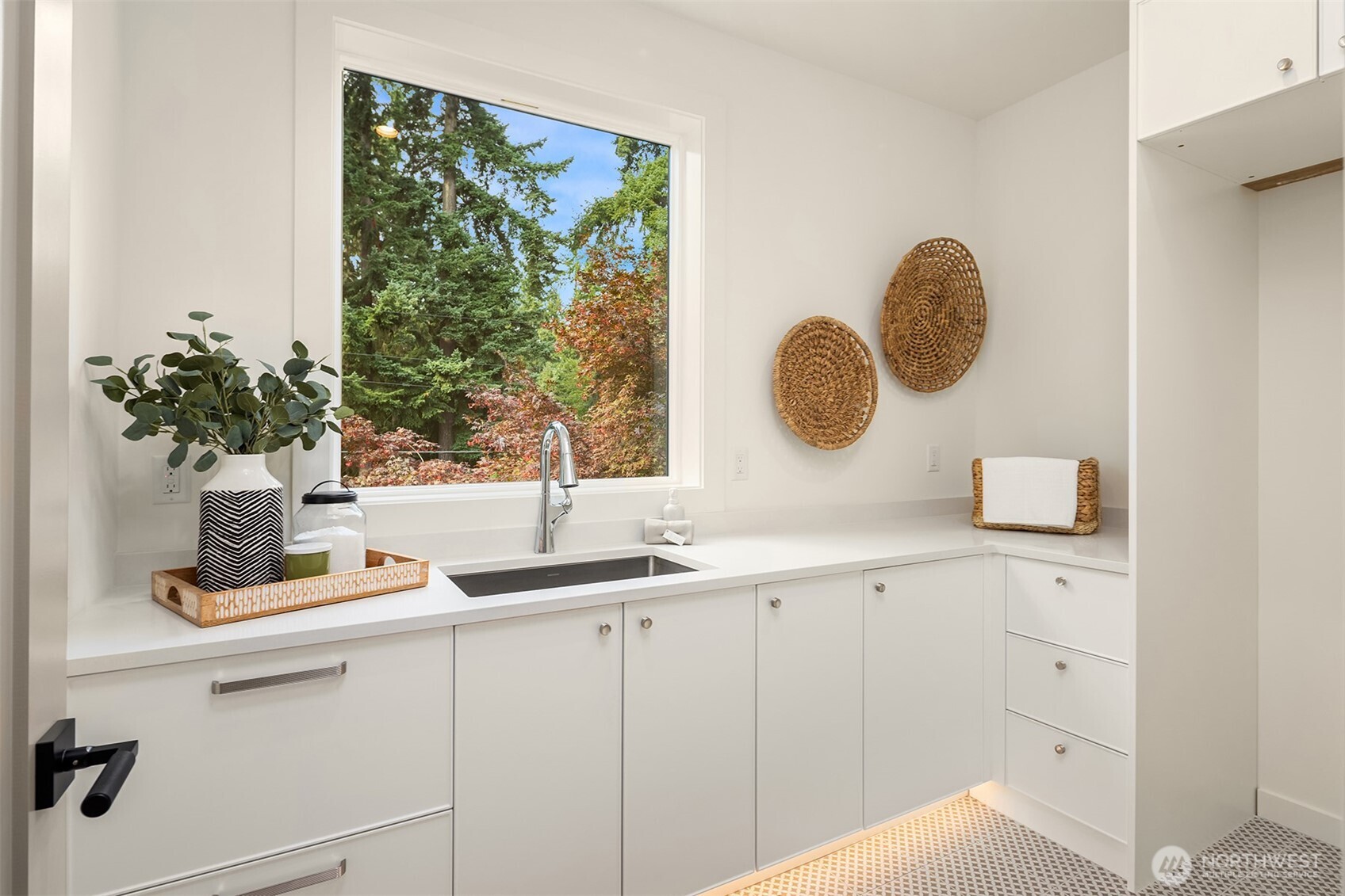 Stunning laundry room with sink, loads of storage and plenty of counter space