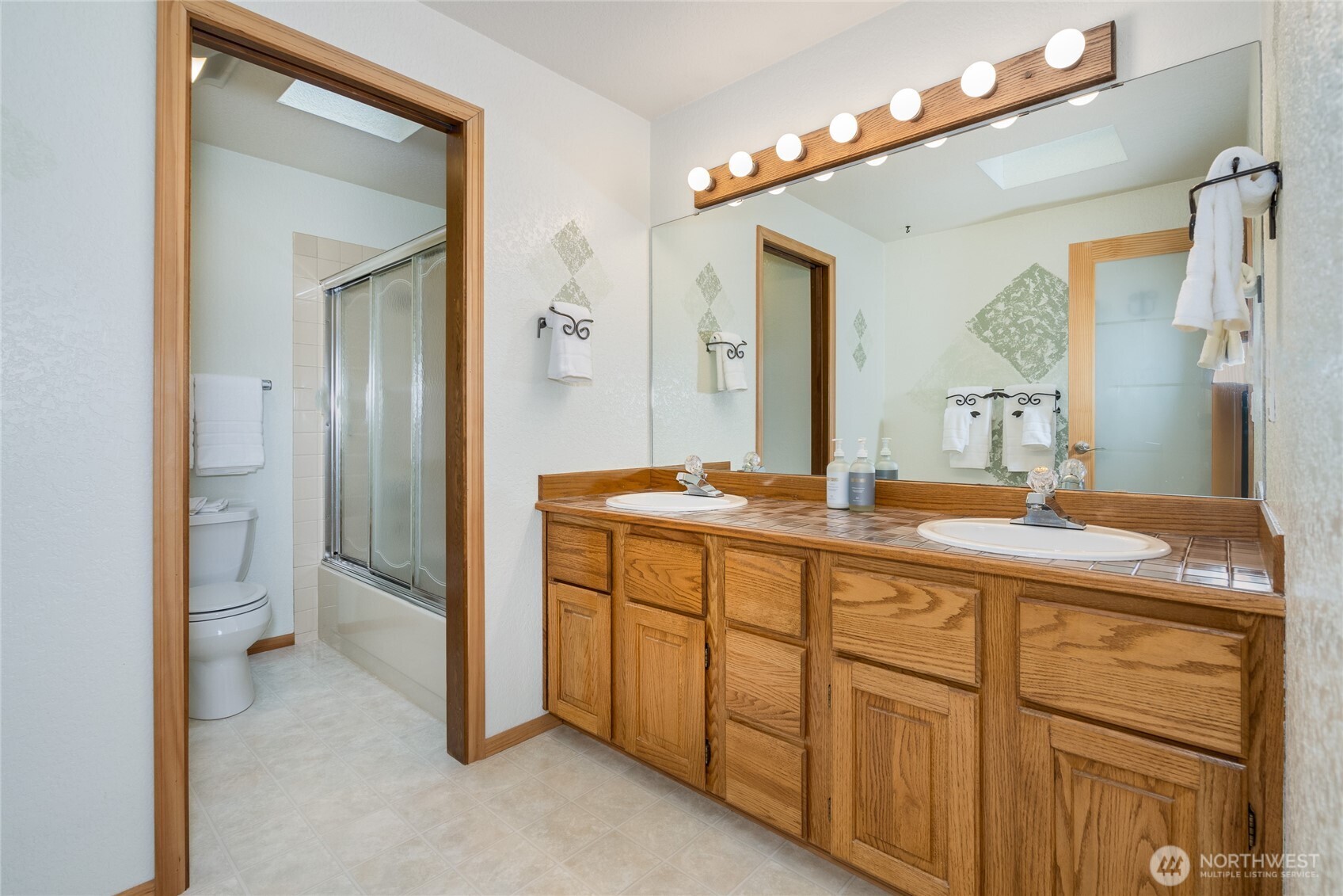 Upstairs Full Hall Bath with separate double sink vanity.