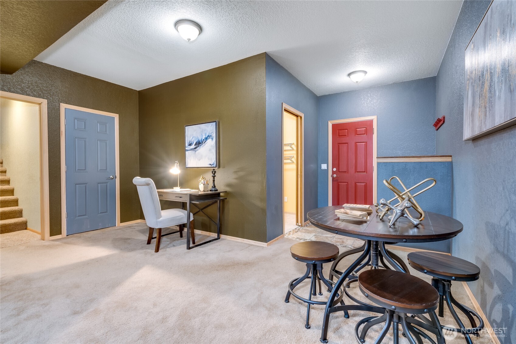 Media room looking towards garage door and extra room and utility room.