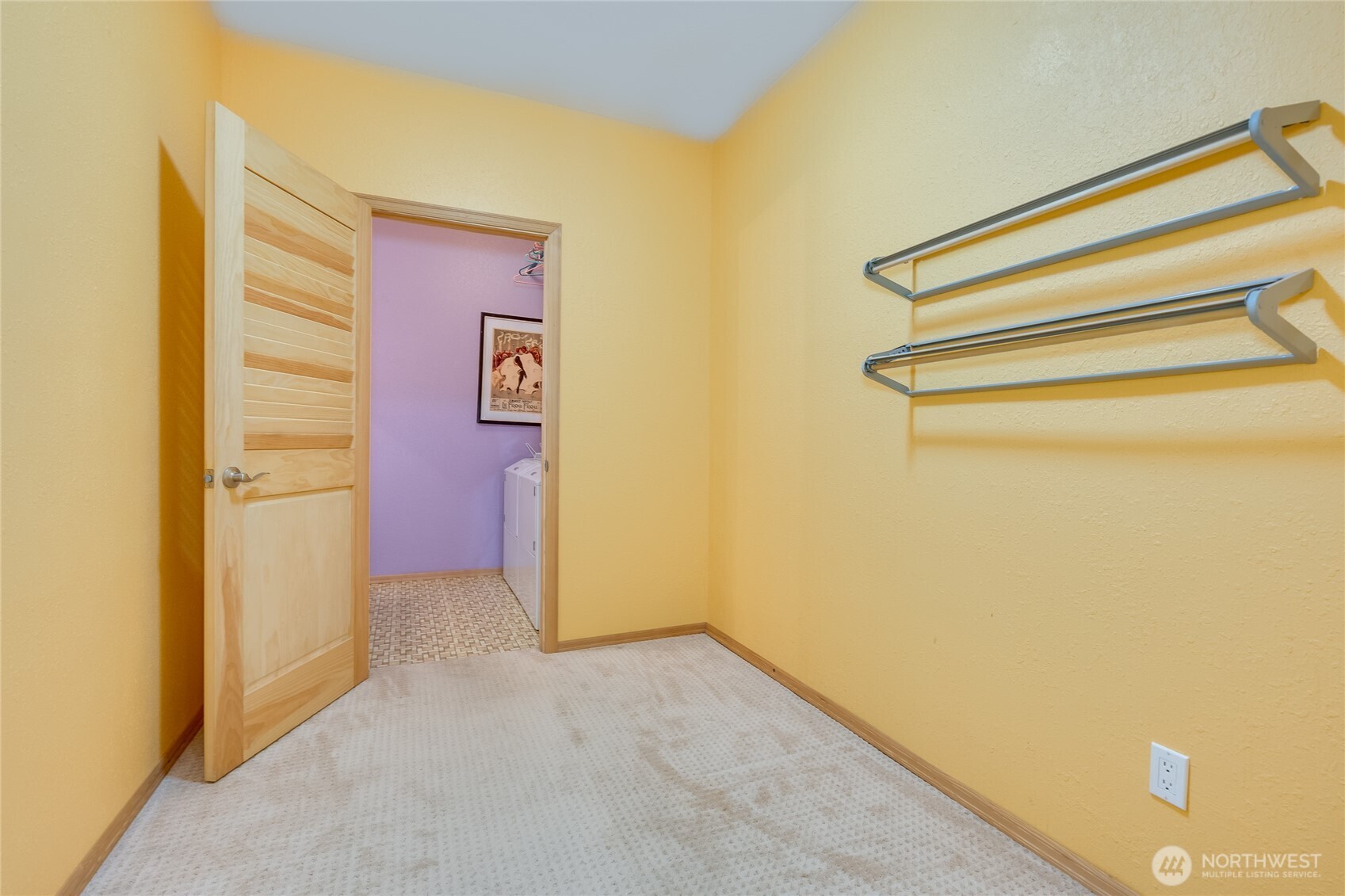 Extra room for crafts, storage, play and utility room with half bath beyond.