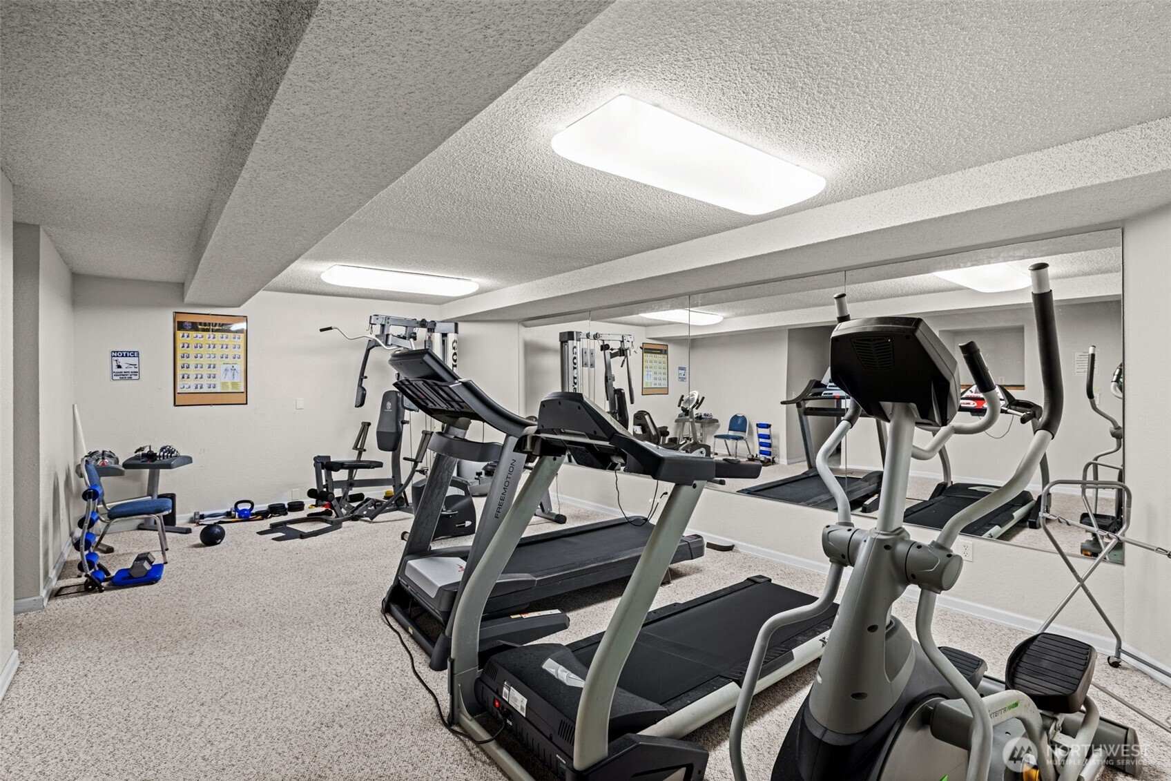 The workout room offers multiple fitness machines.