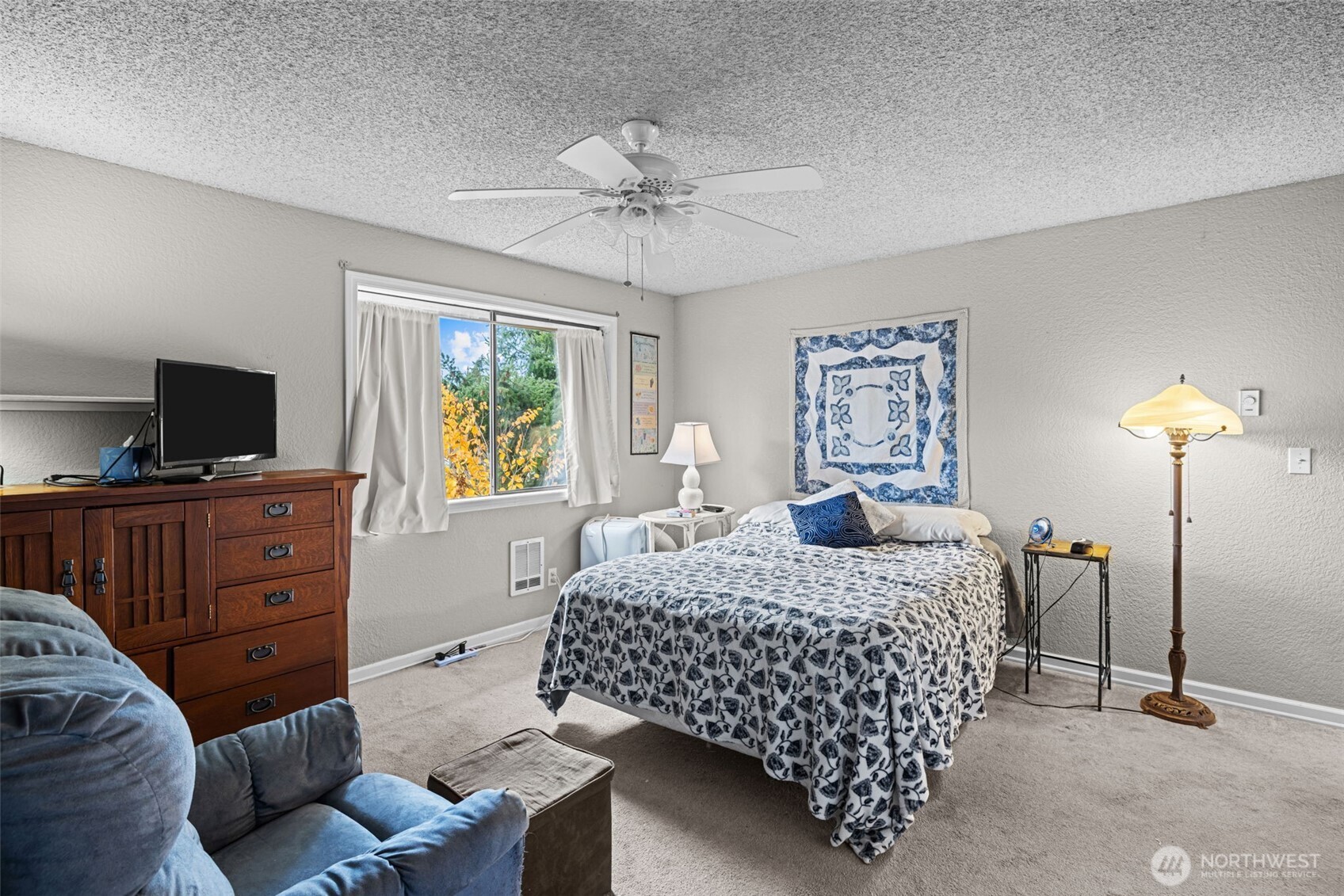 Here is another view of the primary bedroom, which also has a ceiling fan.