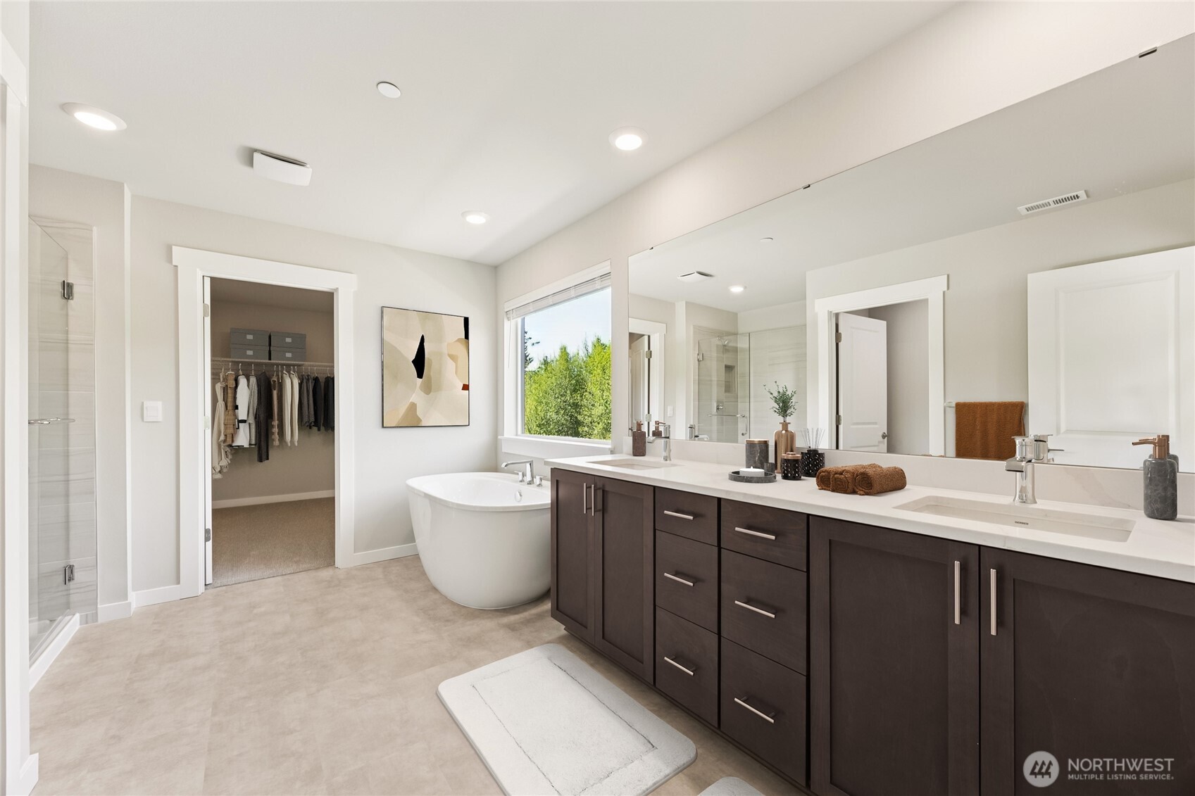 Primary bath with spacious walk-in closet. Virtually staged, showing similar plan.