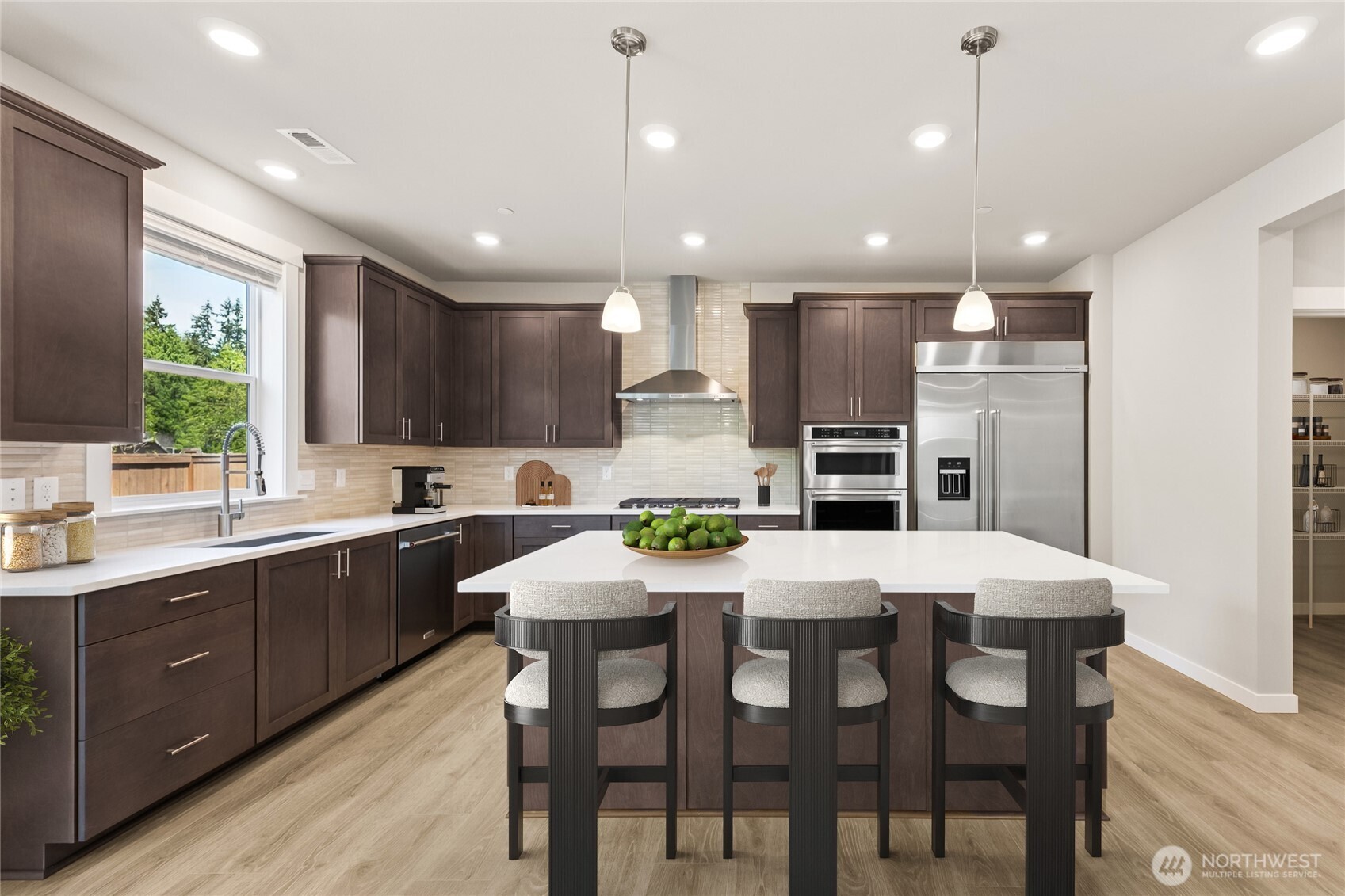 This kitchen and huge pantry offer plenty of space to entertain - Virtually staged, showing a similar floorplan.
