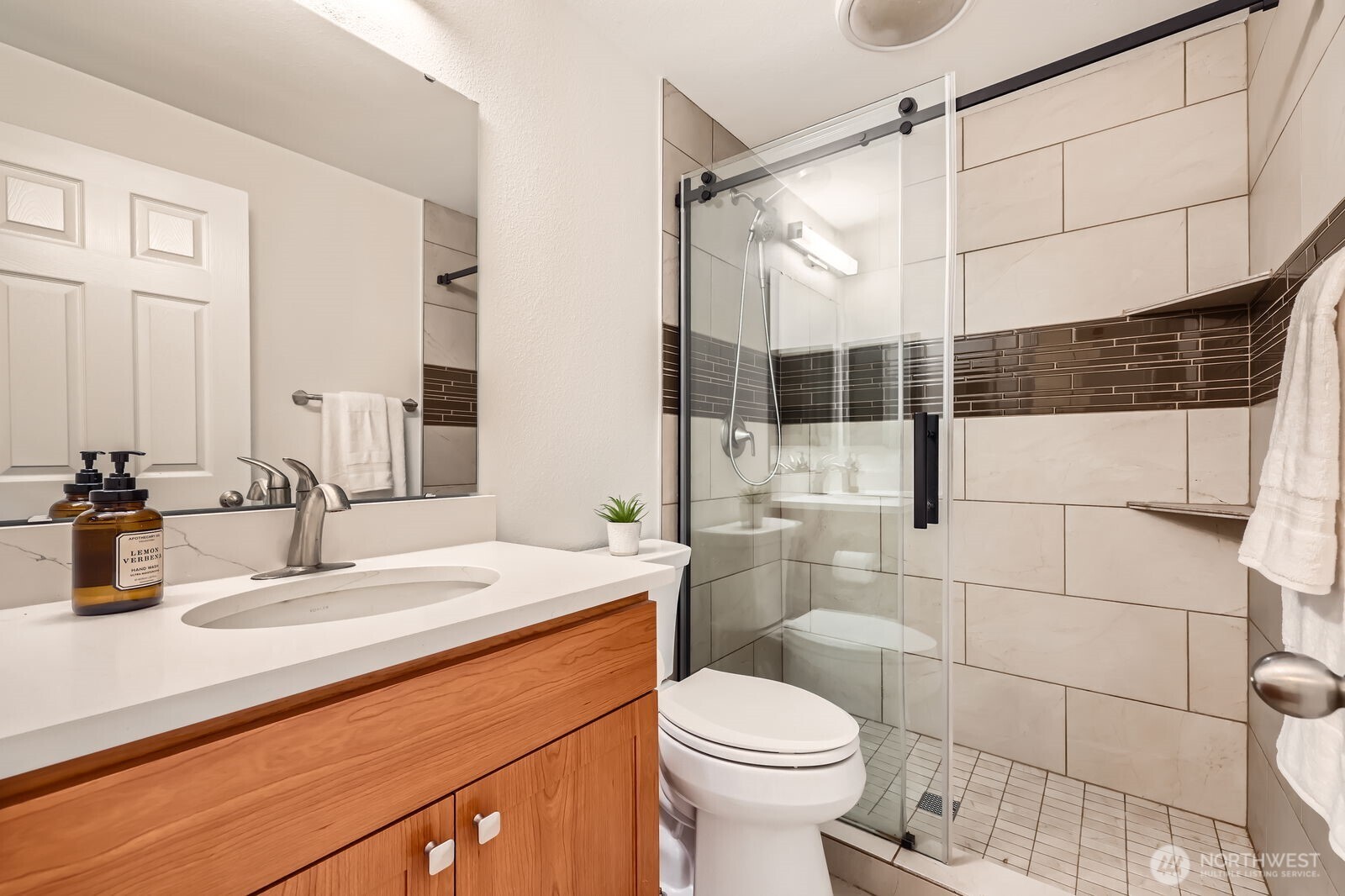 Updated bathroom with stone counters and a large shower