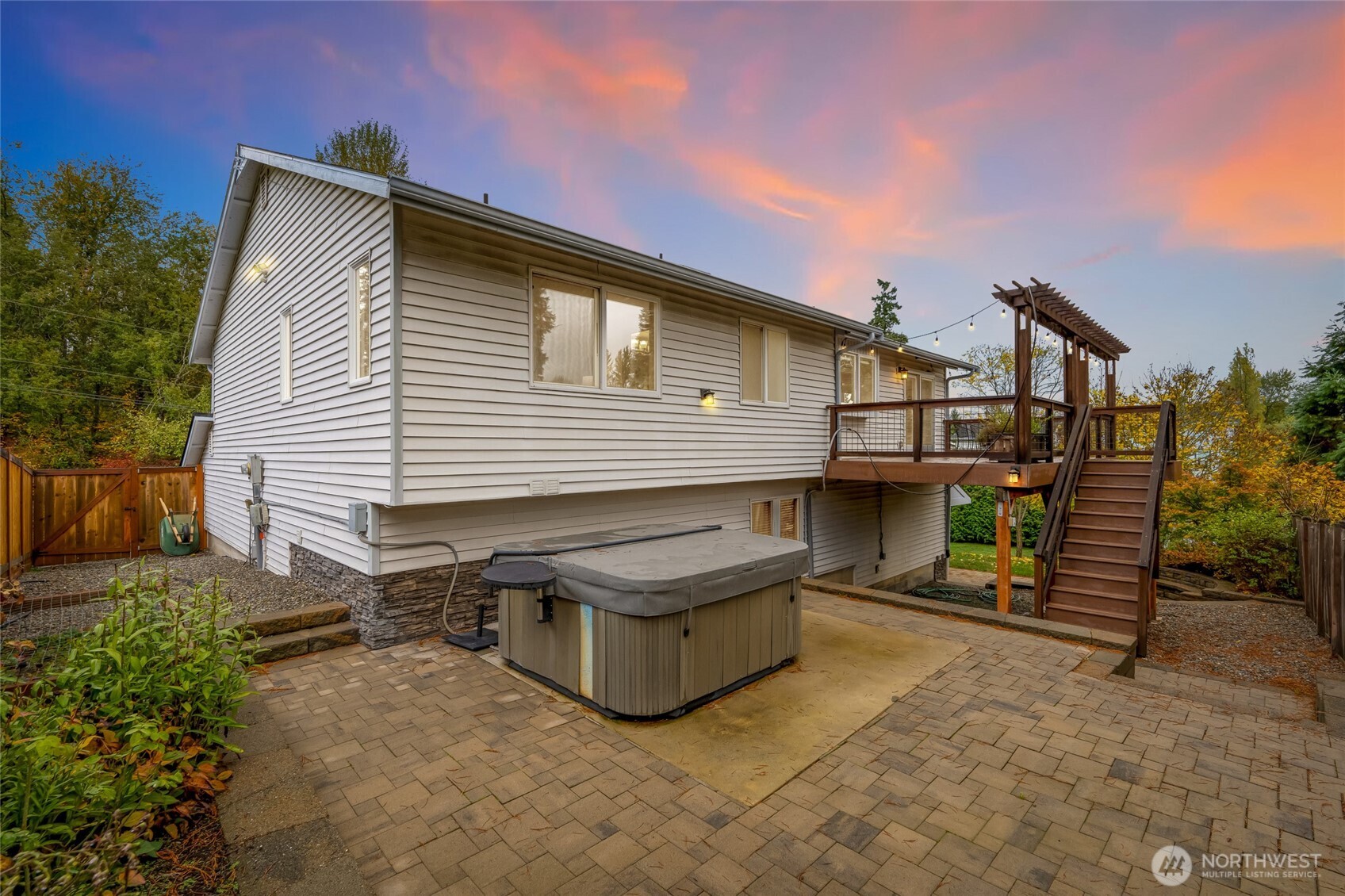 Paver patio with a private hot tub area and easy access to the deck above. Ideal for relaxing evenings or hosting friends outdoors.