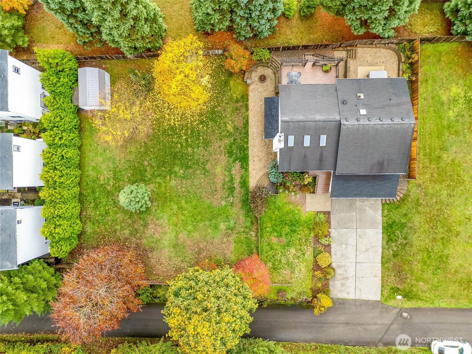 A true sense of space! The large fenced yard with huge side yard, entertainment deck, and mature trees offering a natural backdrop.