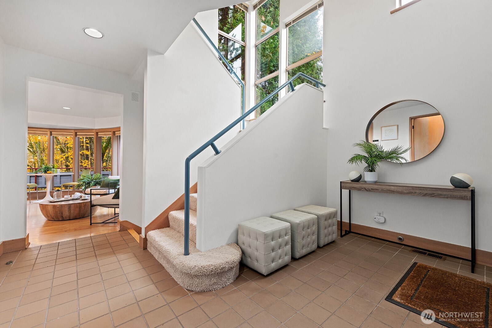 Tiled entry with an open staircase to the second floor.