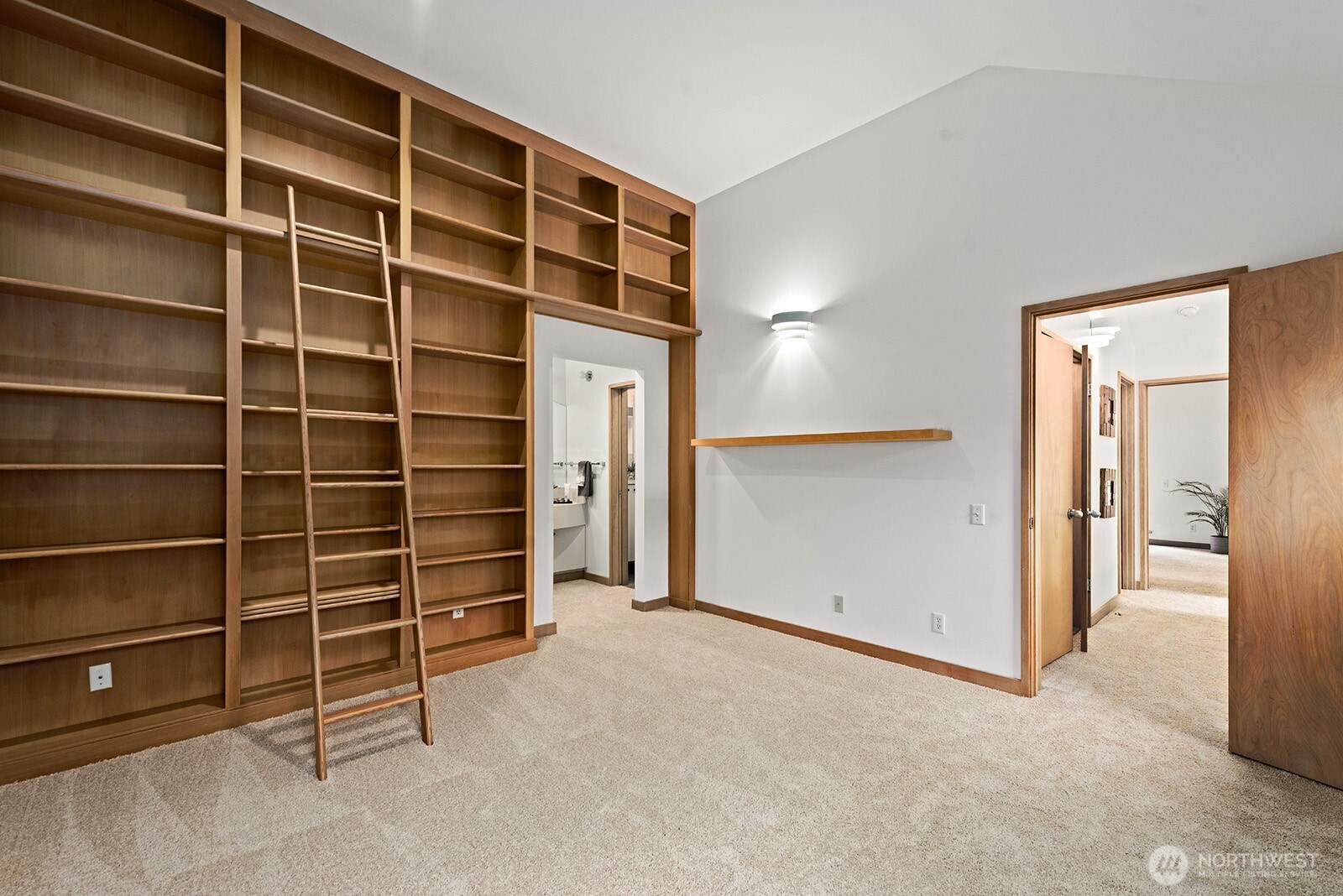 Second bedroom has bookshelves and a walk-in closet.