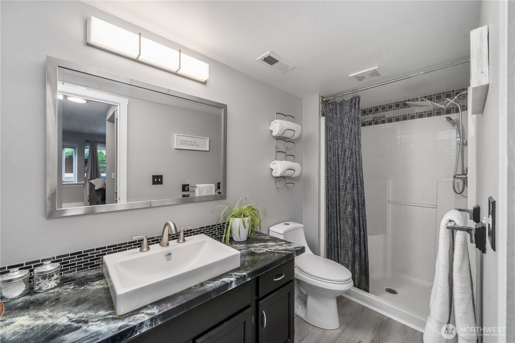 Chic 3/4 bathroom located on the lower level.