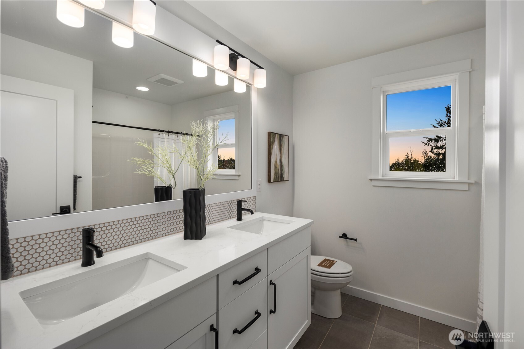 Upper Hall Bath: Full bath features a dual vanity with quartz counters, modern fixtures, and stylish tile details. Perfectly situated to serve the secondary bedrooms with convenience and comfort.    Photos are from THIS model home at Foxmoore but are for visualization purposes only.