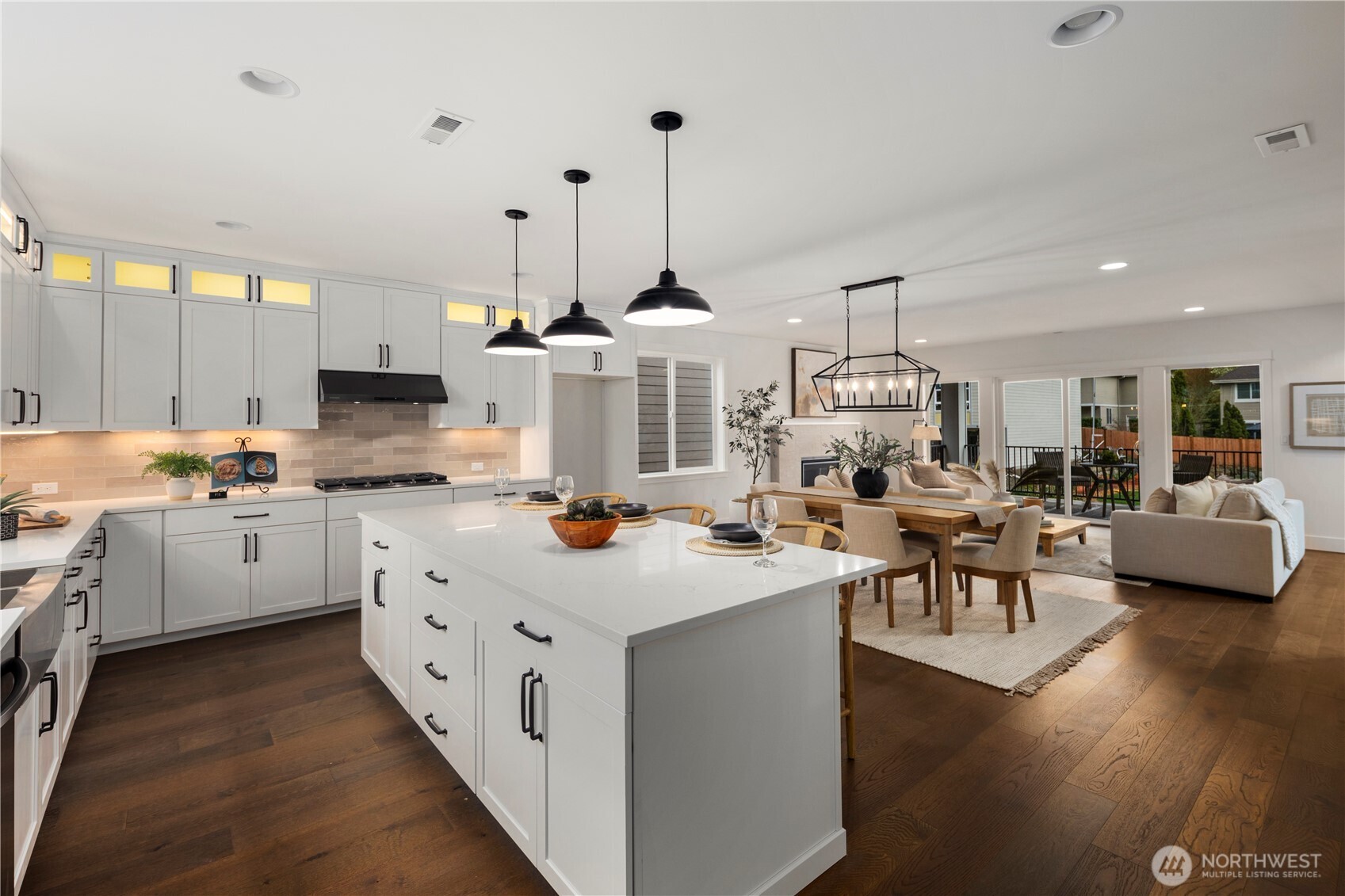 Kitchen & Great Room Overview: Oversized island overlooks dining and great room, showcasing the seamless connection between spaces. Ideal for hosting or daily routines, the design emphasizes flexibility, light, and comfort in a sought-after Eastside location.    Photos are from THIS model home at Foxmoore but are for visualization purposes only.  Photos are from the model home at Foxmoore and for visualization purposes only. Plans, colors, building orientation, finishes, home outlook, and other details can and WILL vary.