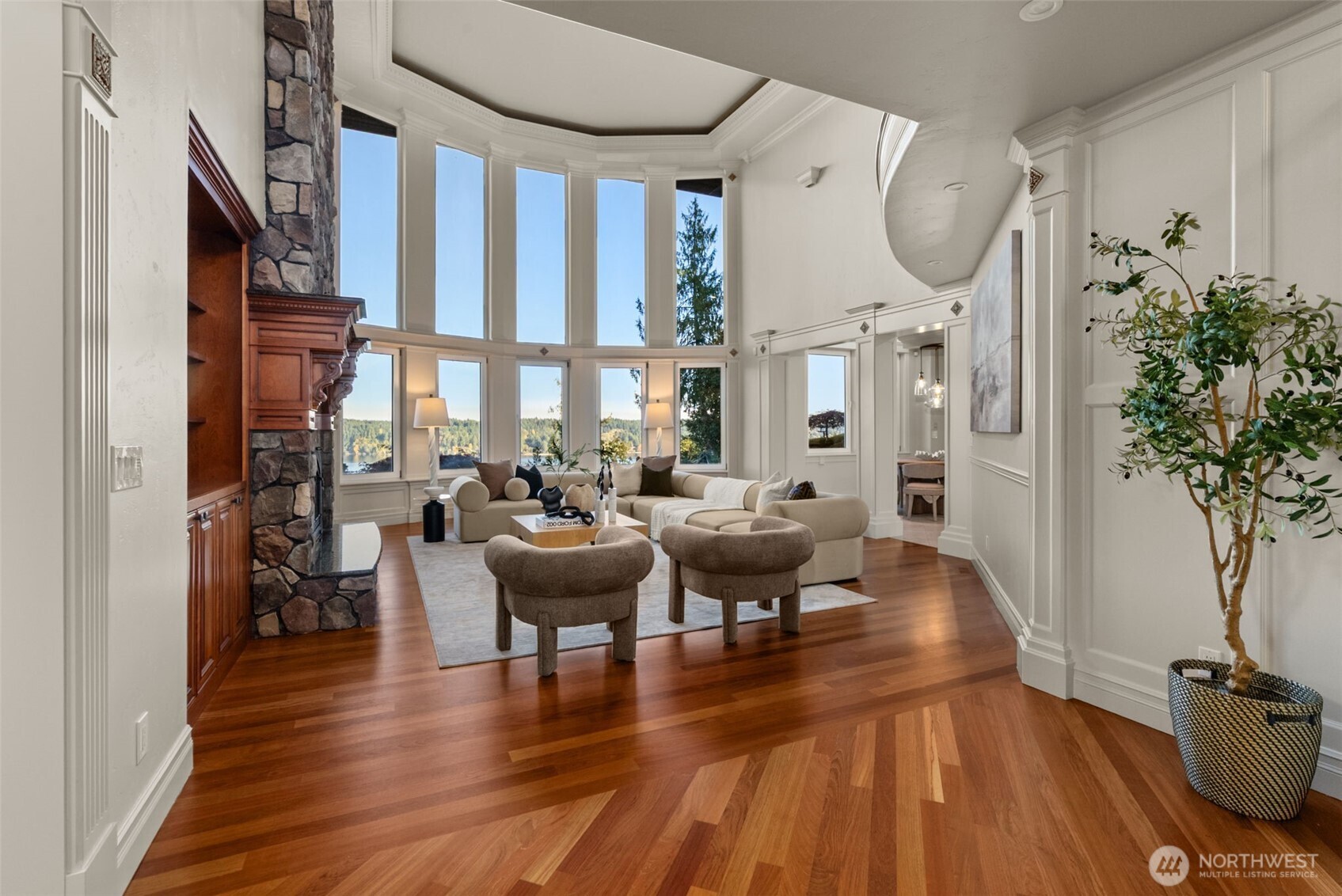 The grand entry continues into the great room with floor to ceiling windows allowing the outside, in.