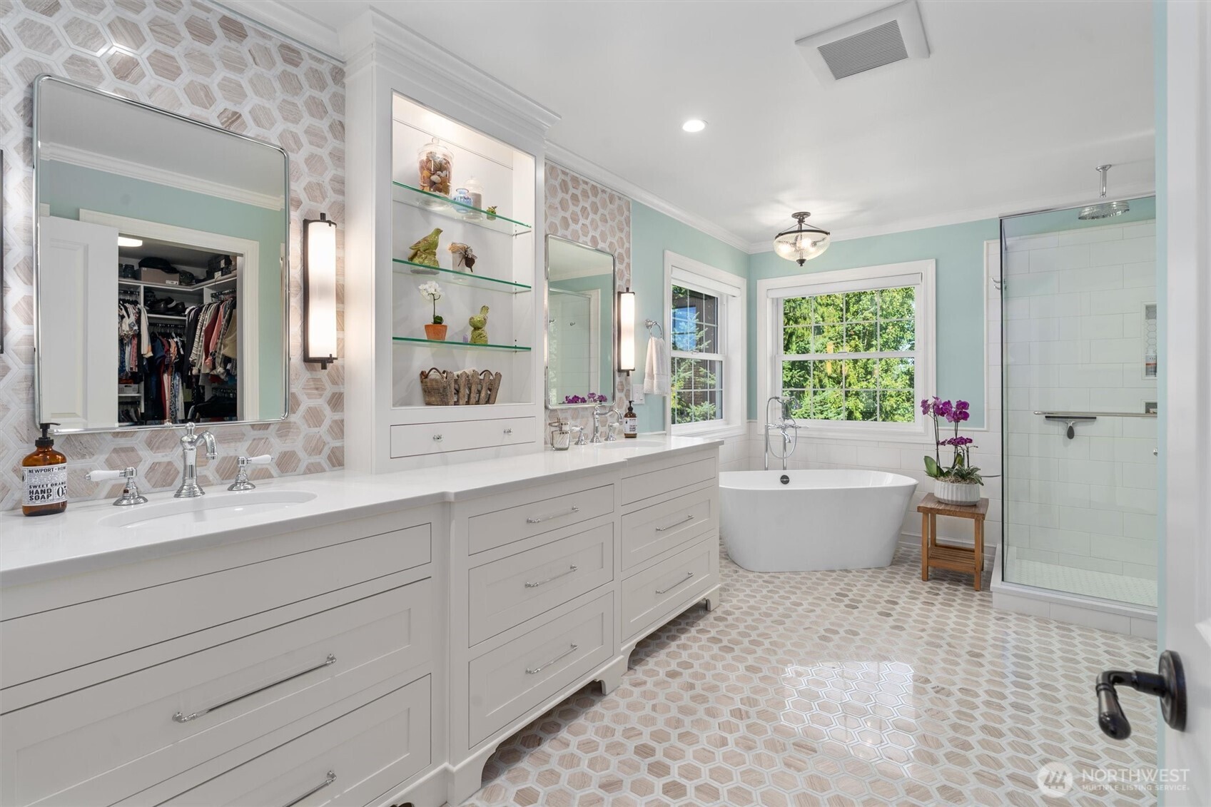Luxurious bathroom with Limestone marble floors, Quartz countertops, Italian Rohl faucets, and Victoria & Albert tub, and walk-in closet from California Closets.