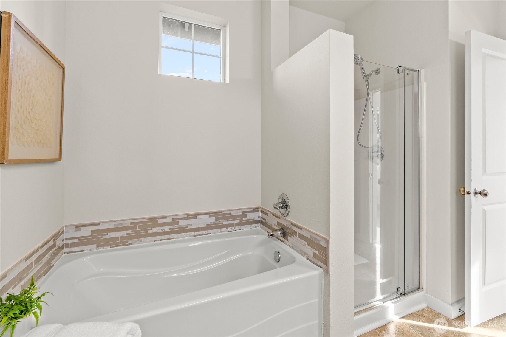 Large soaker tub with tile accents.