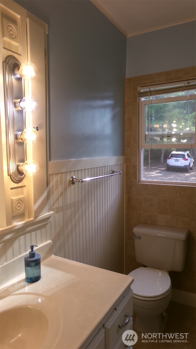 Main floor Bathroom, Mini Reno! Shower tub adjacent to the sink. Storage closets too!