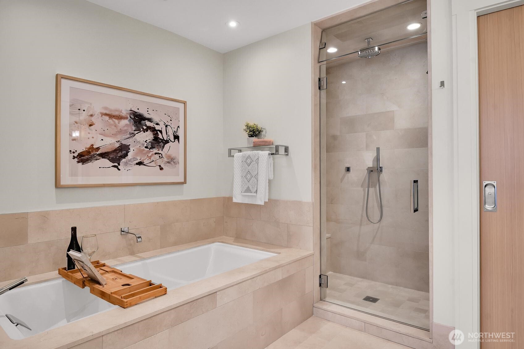 Soaking tub and steam shower in the Primary bathroom of Unit 1205