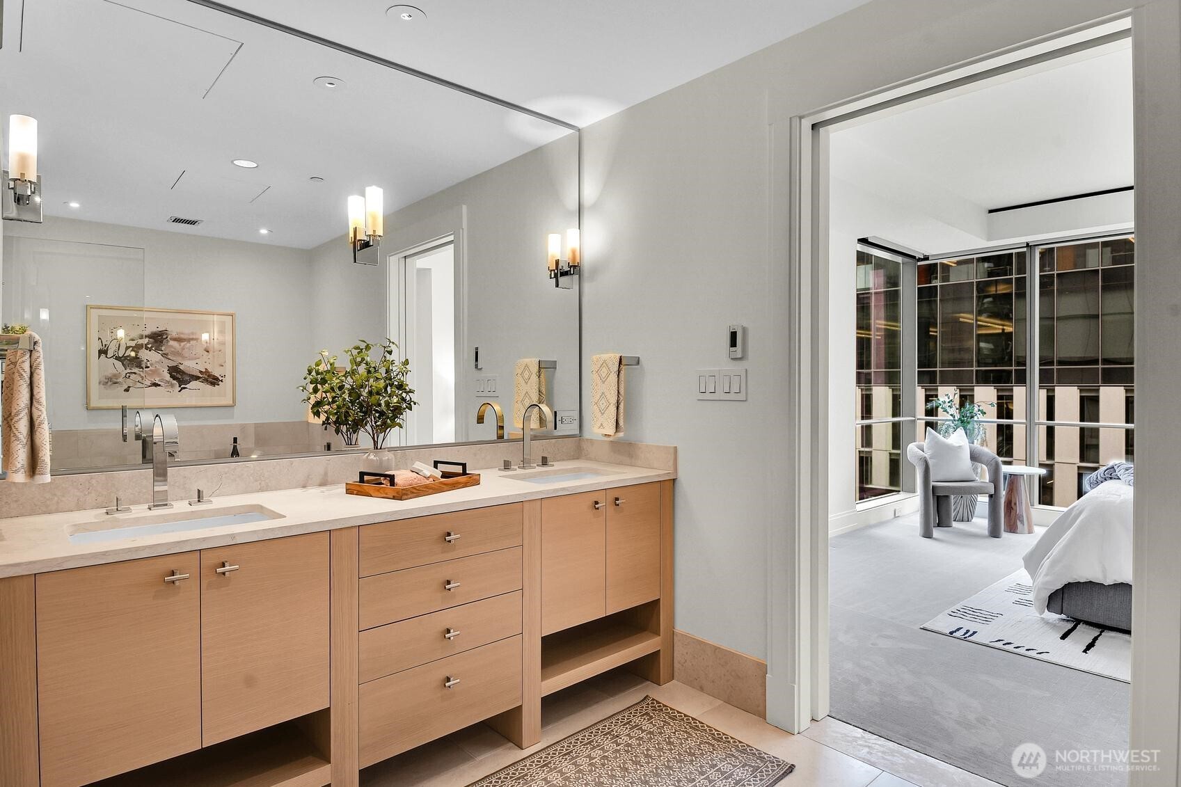 Stone countertops and dual vanities in the Primary bath of Unit 1205