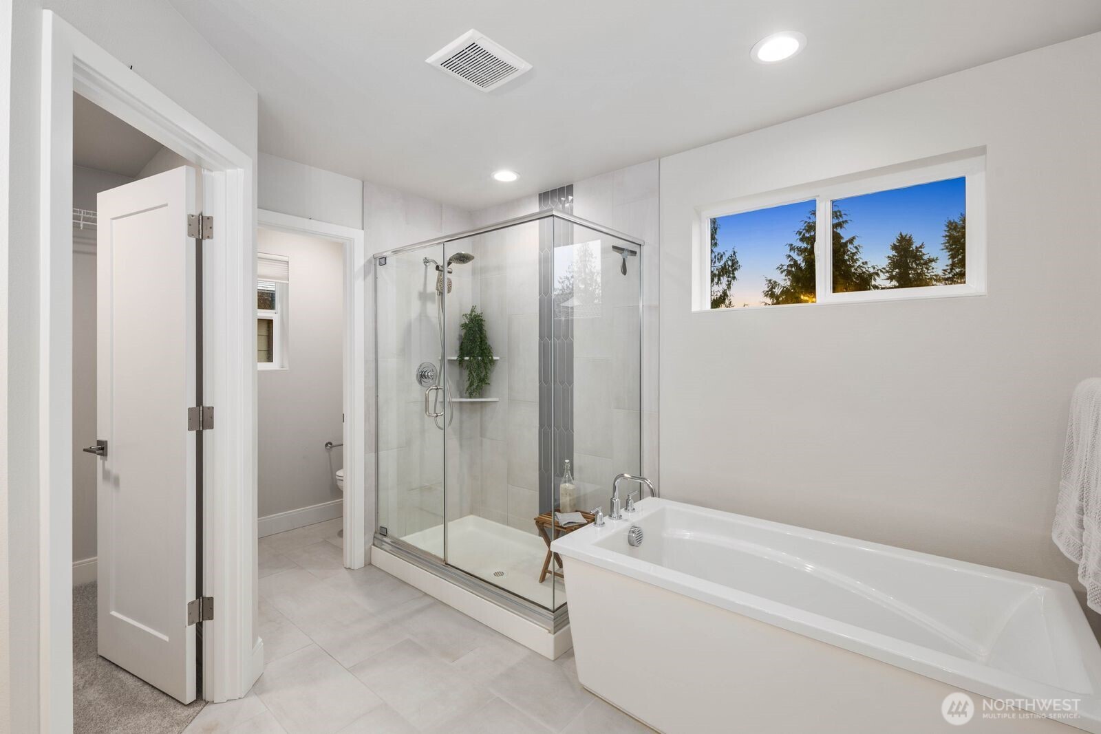 Primary suite with soaking tub, walk-in closet, and water closet.