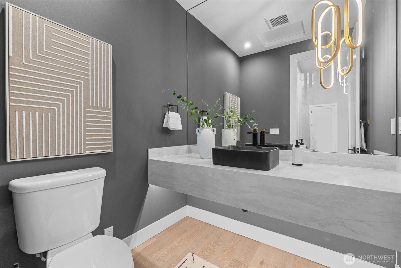 Main level "powder" bath with stunning floating vanity with motion sensor under cabinet lighting