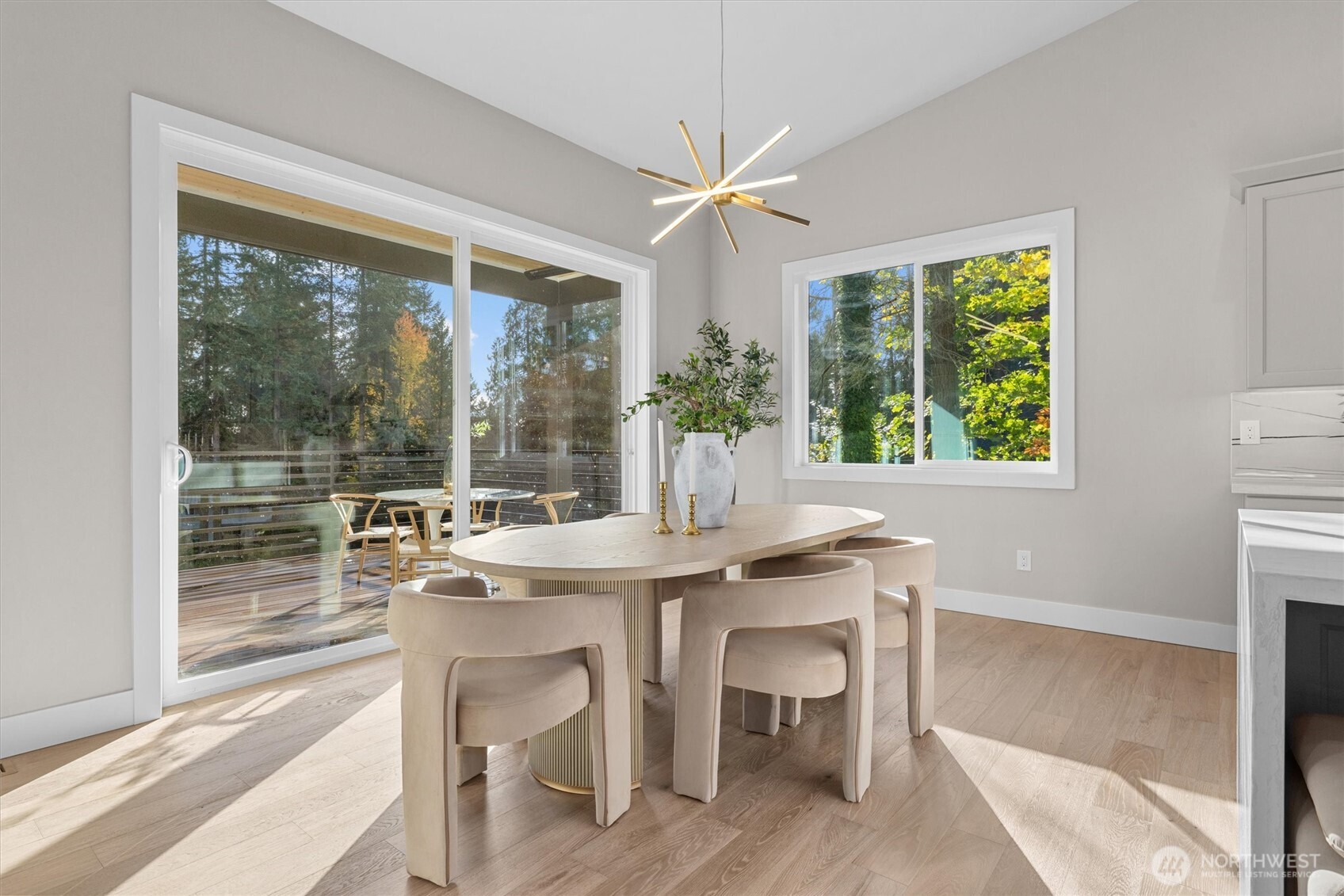 Dining area leads to covered outdoor living space with heat lamps for all-season enjoyment