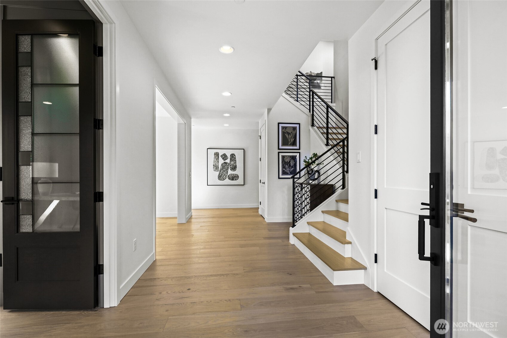 Open and welcoming entry foyer with the office on the left. Chaffey Building Group always have exquisite millwork wrapped doorways and windows. Gorgeous warm color to the wide plank engineered hardwoods.