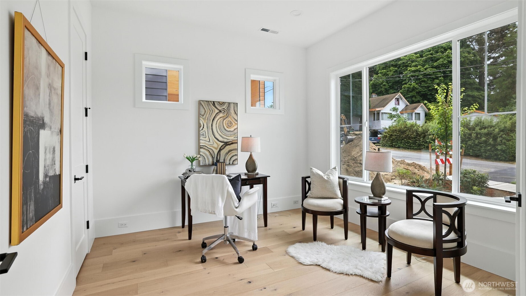 Great Room and Kitchen Connection:  Thoughtfully designed for light, flow, and connection, the main living space blends modern warmth with everyday livability. Wide-plank floors carry throughout, guiding you from the inviting dining area to the sunlit great room anchored by a sleek, tile-wrapped fireplace. Oversized windows bring the outdoors in, enhancing the sense of openness and calm.