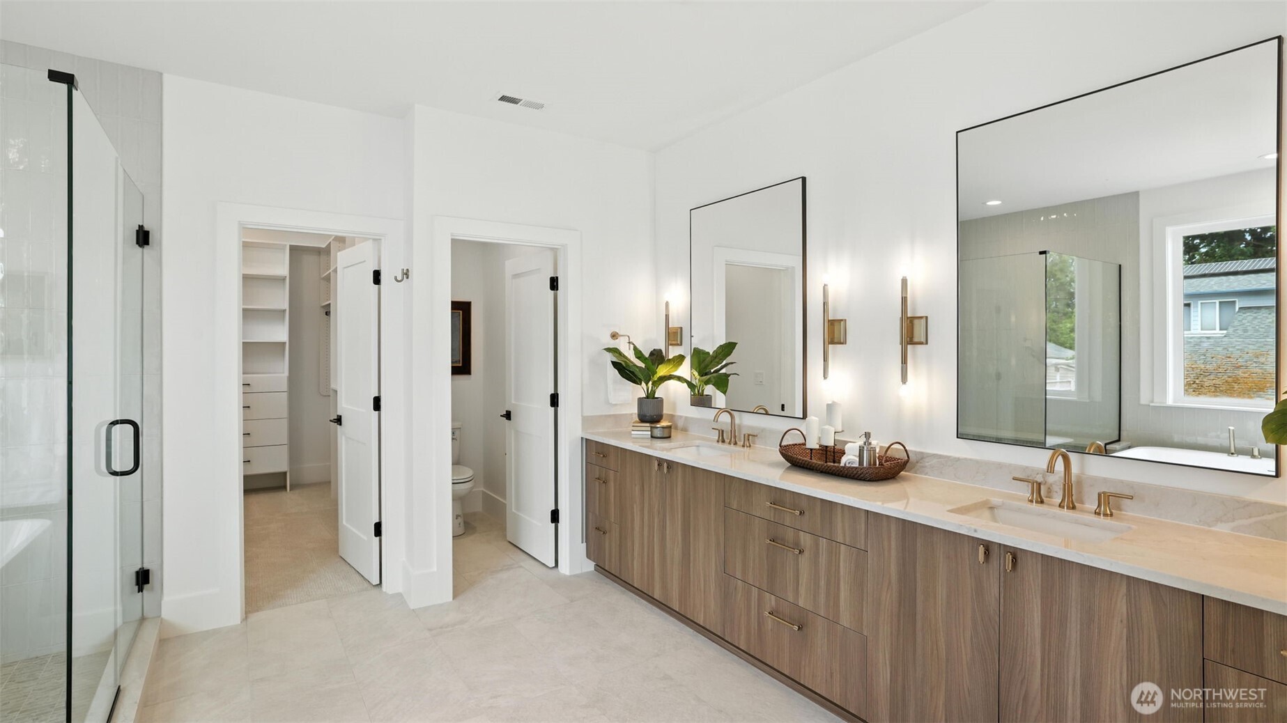 The kitchen pairs clean architectural lines with functional luxury — professional-grade appliances, a Thermador double-oven gas range, soft-close cabinetry, and a generous walk-in pantry ready for effortless hosting. The oversized island centers the home, perfect for morning coffee, casual meals, or lively evenings with friends. Every detail reflects craftsmanship that balances sophistication with ease.