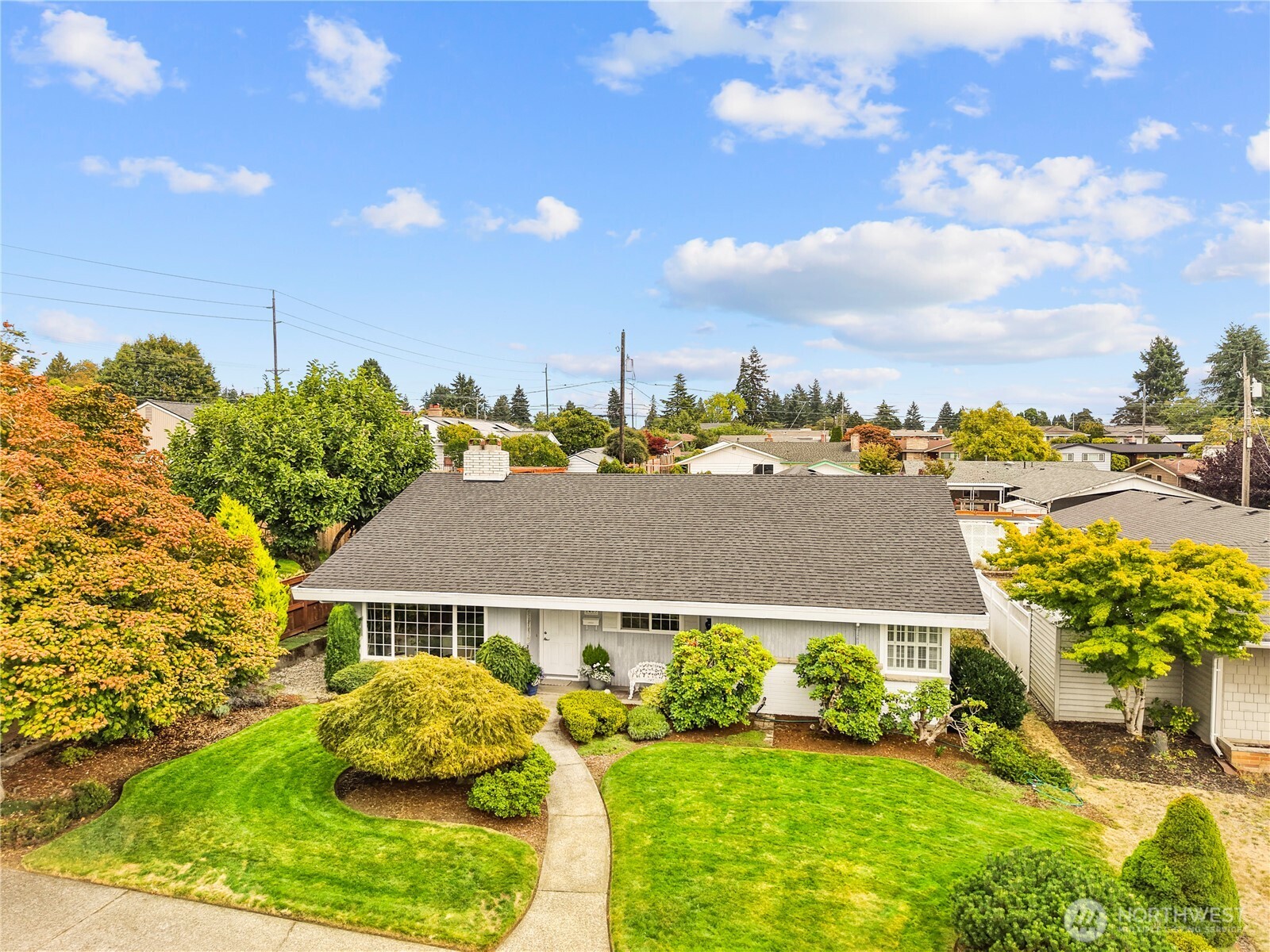 1463 N Winnifred. Lush front yard with mature landscaping. Above ground sprinkler set up in front yard.